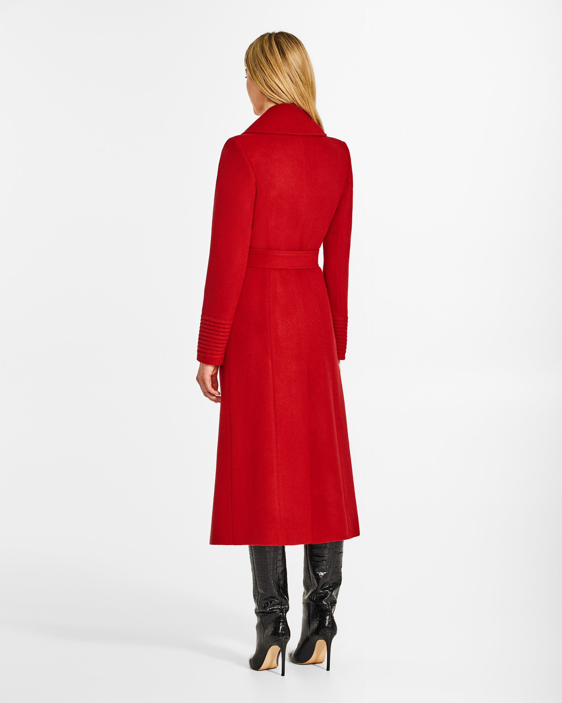 Back view of model wearing a SENTALER long scarlet red wrap coat made of baby alpaca wool, with a large notched collar, worn belted.