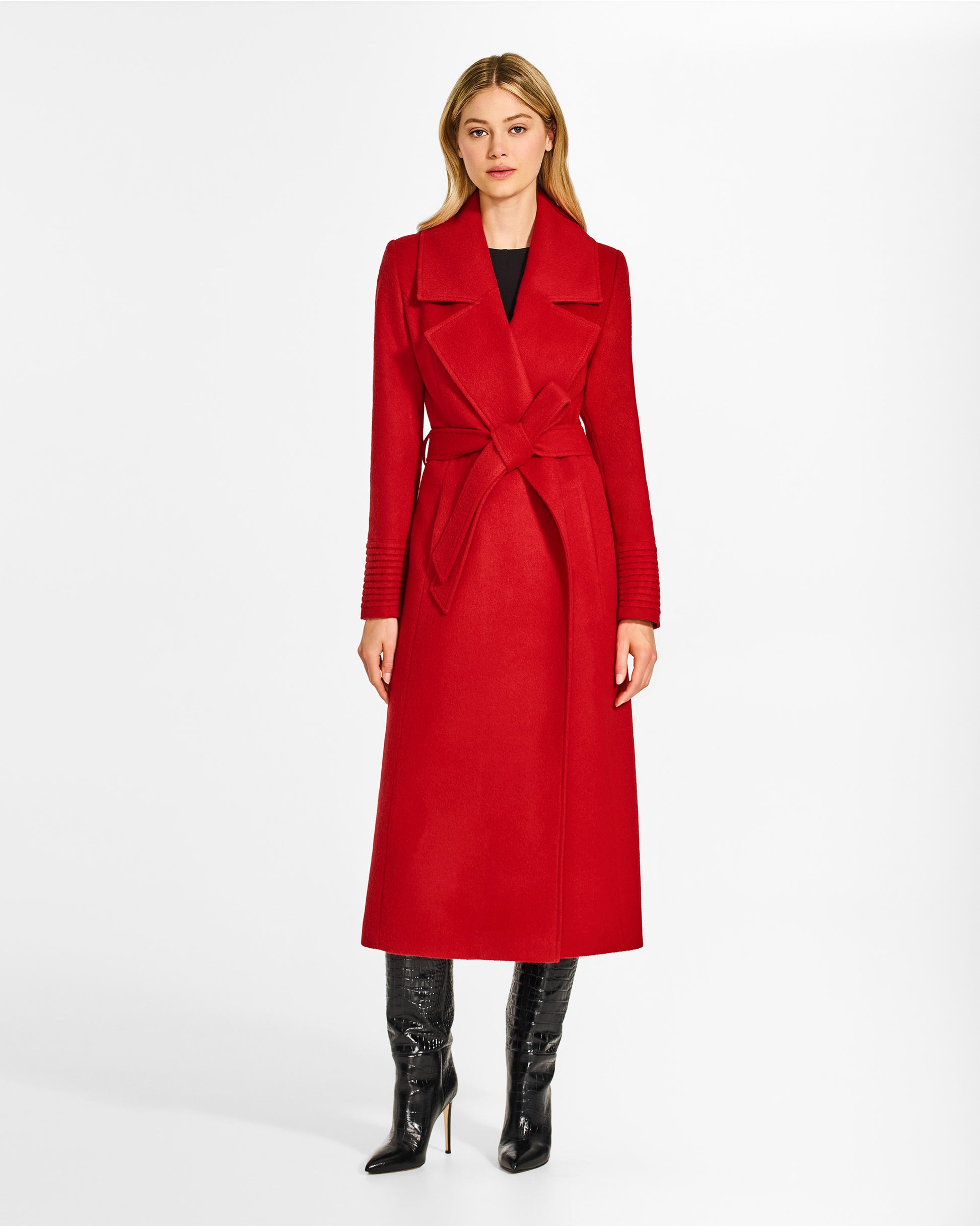 Front view of model wearing a SENTALER long scarlet red wrap coat made of baby alpaca wool, with a large notched collar, worn belted.