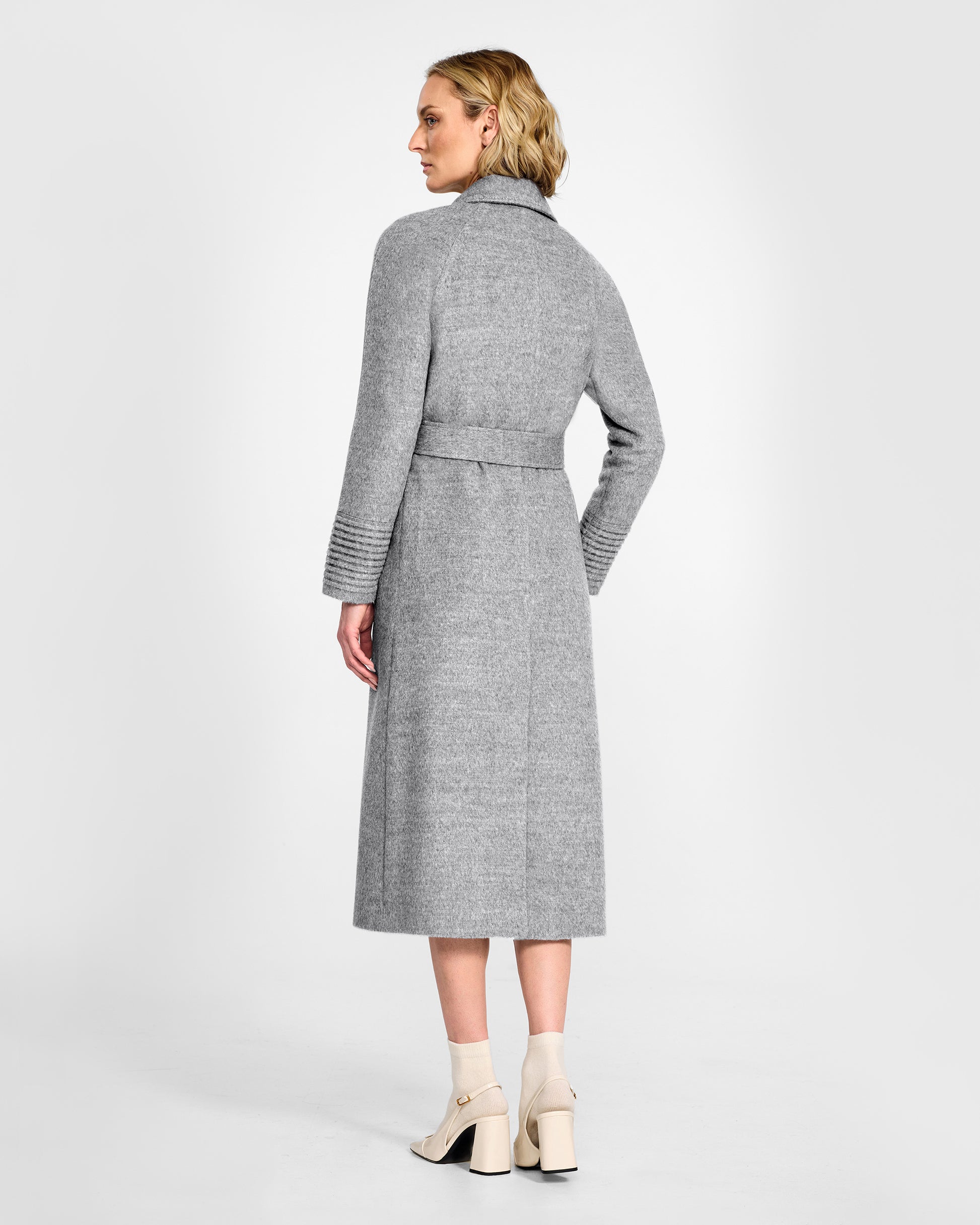 Back view of model wearing a SENTALER long shale grey wrap coat made of baby alpaca wool, with raglan sleeves, worn belted.