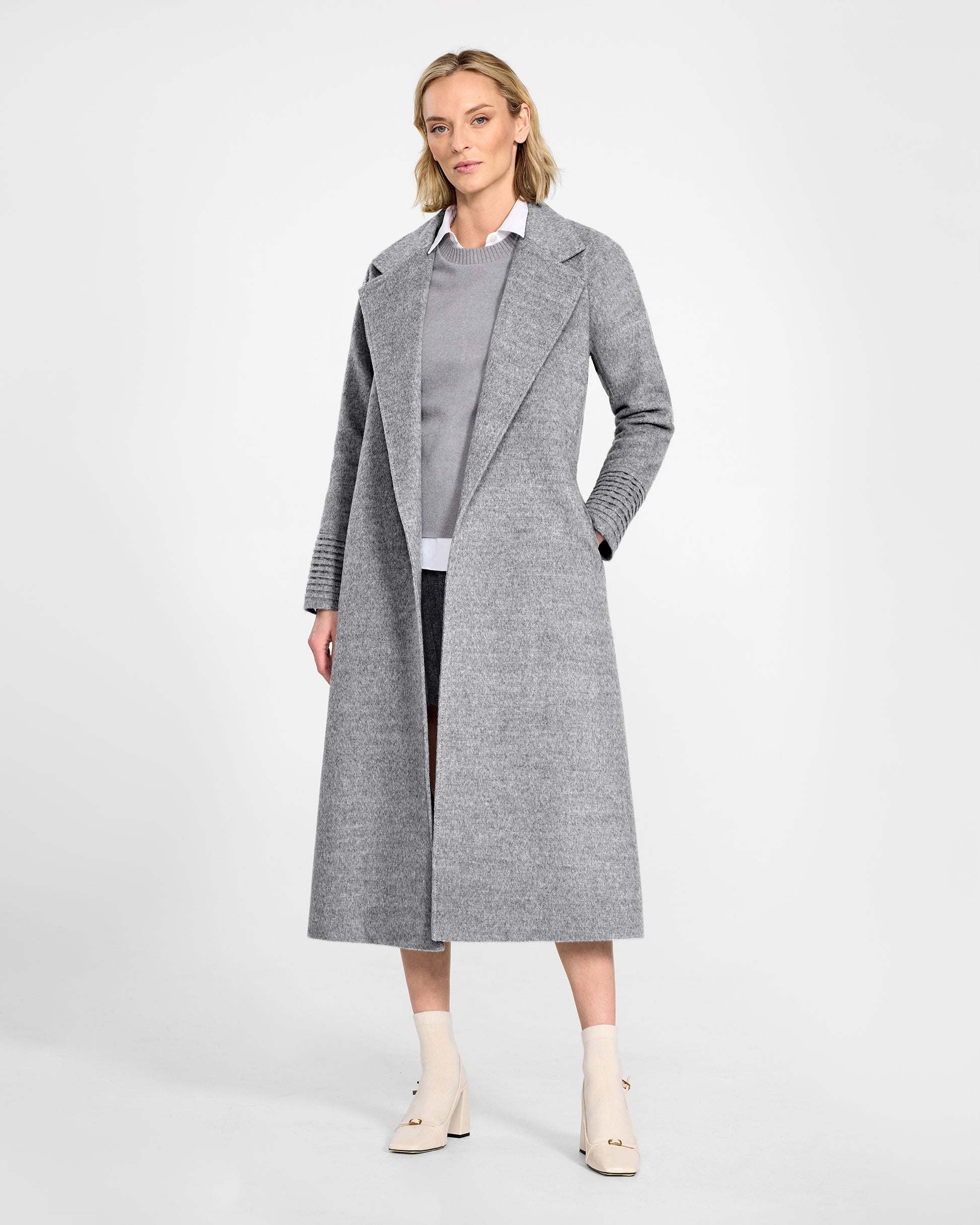 Front view of model wearing a SENTALER long shale grey wrap coat made of baby alpaca wool, with raglan sleeves, worn open.