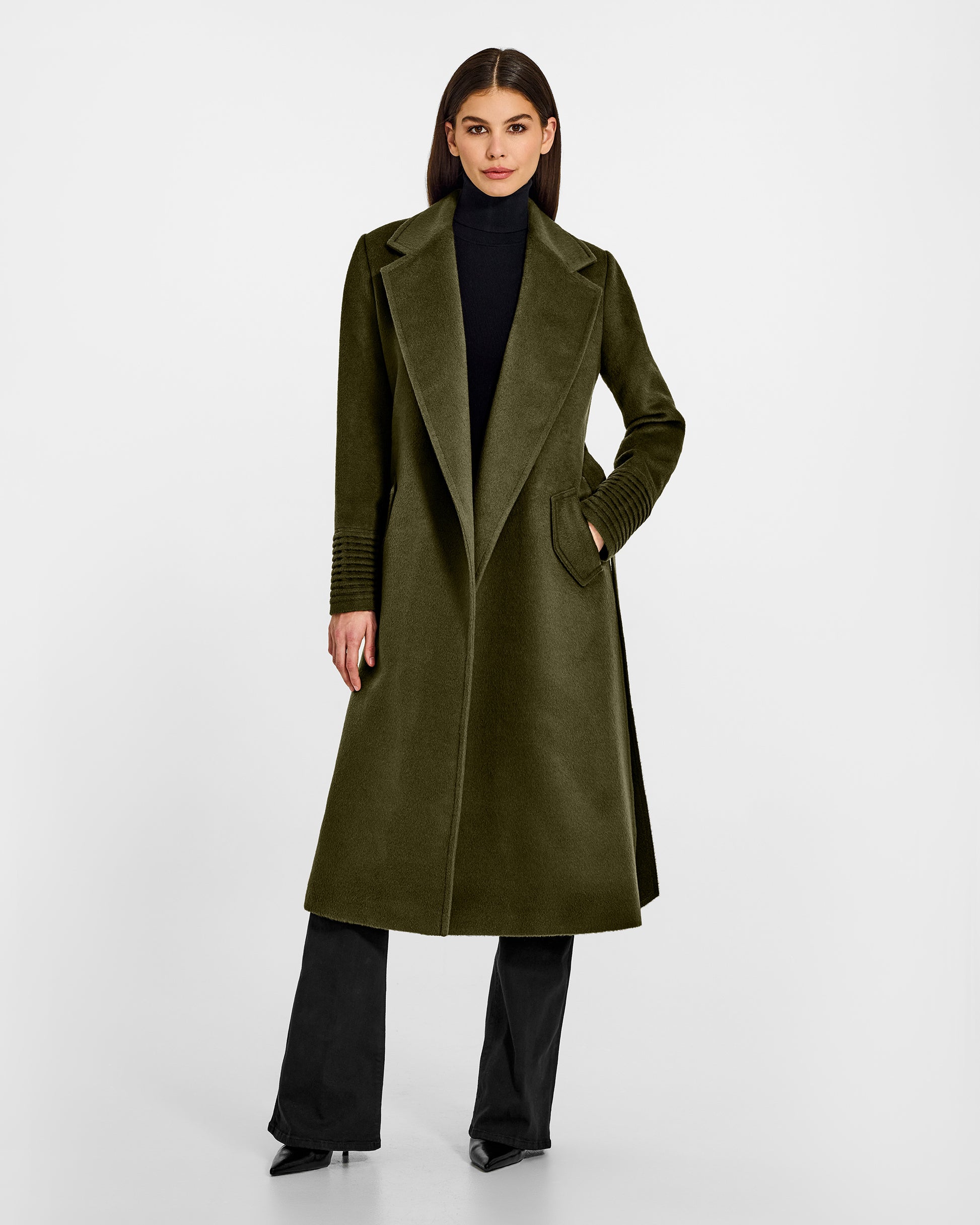 Front view of model wearing a Sentaler long olive green wrap coat made of baby alpaca wool, with a notched collar, worn open.