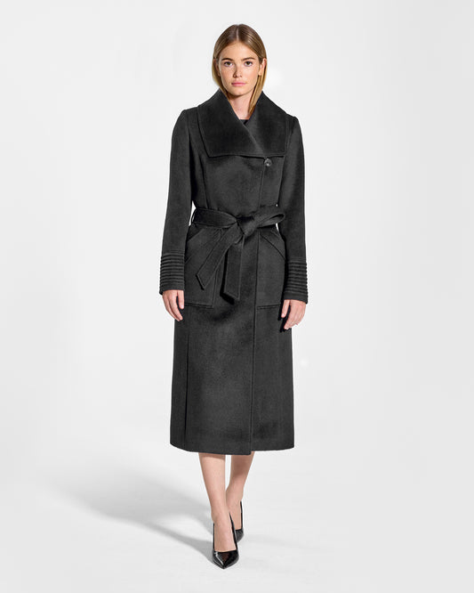 Front view of model wearing a Sentaler black long wrap coat made of baby alpaca wool, with a wide collar, worn belted.