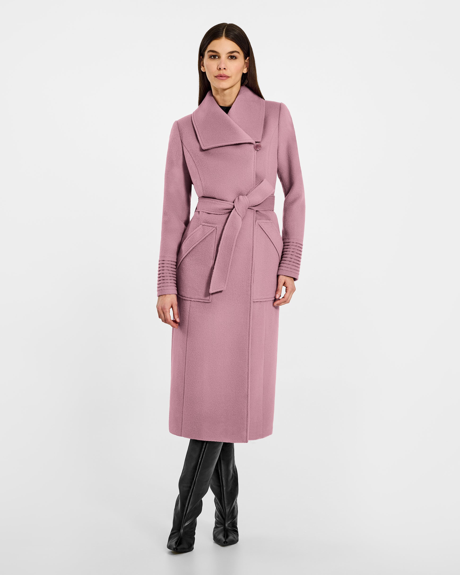 Front view of model wearing a Sentaler peony pink long wrap coat made of baby alpaca wool, with a wide collar, worn belted.