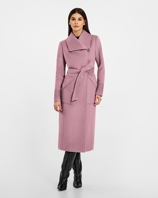 Front view of model wearing a Sentaler peony pink long wrap coat made of baby alpaca wool, with a wide collar, worn belted.