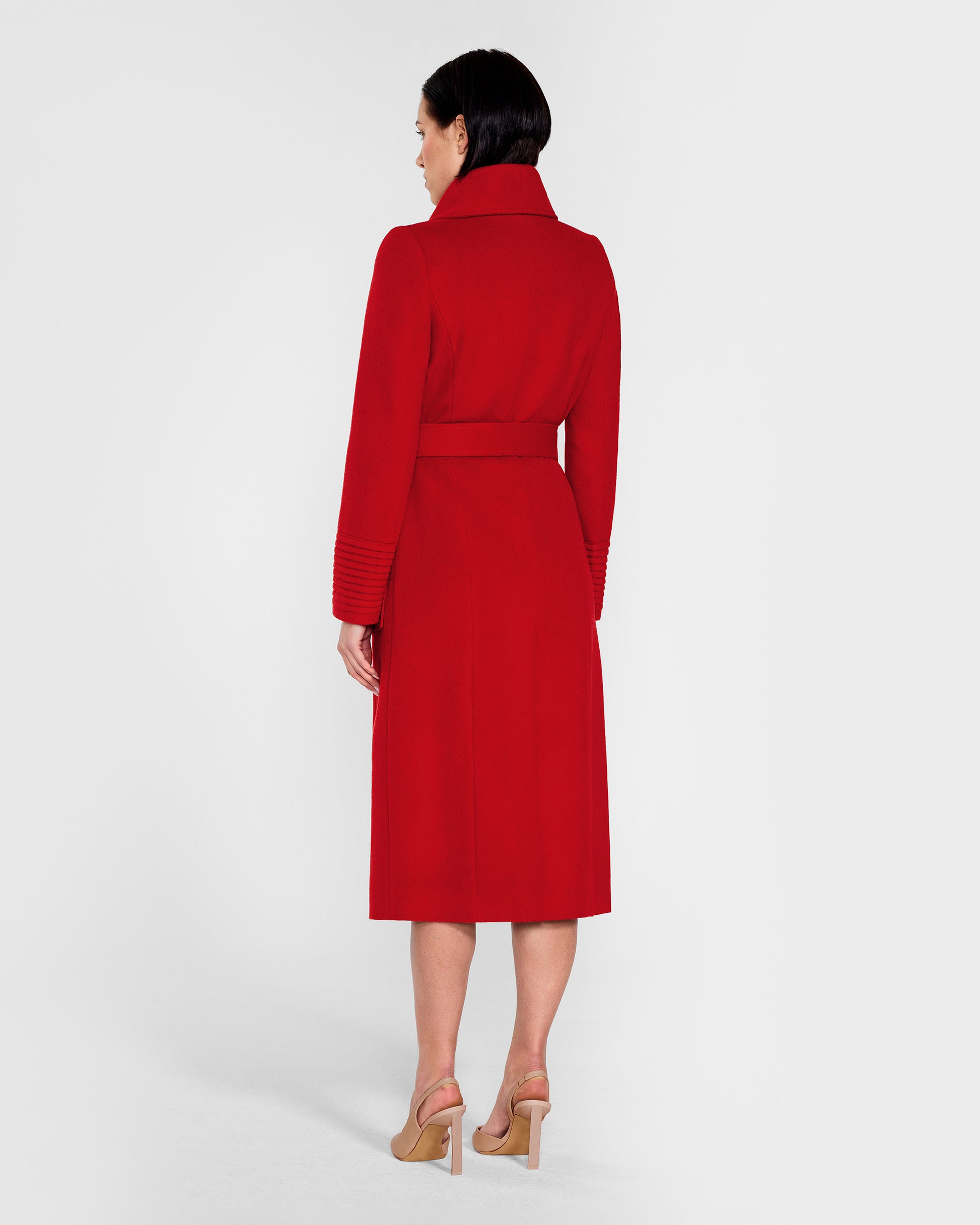 Back view of model wearing a Sentaler scarlet red long wrap coat made of baby alpaca wool, with a wide collar, worn belted.