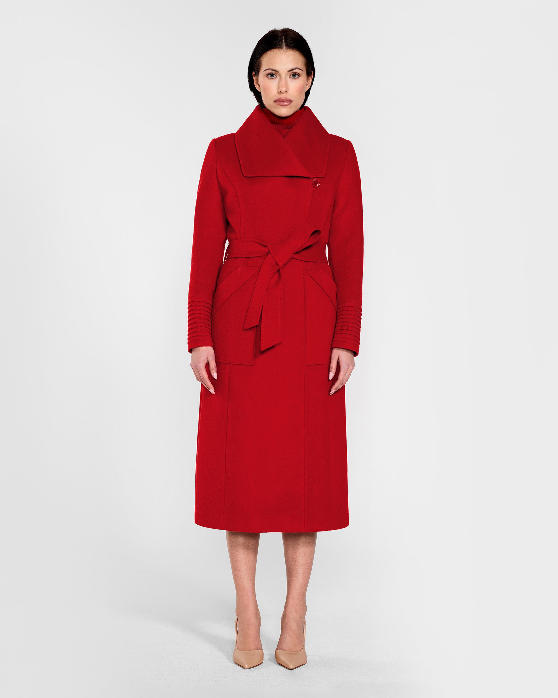 Front view of model wearing a Sentaler scarlet red long wrap coat made of baby alpaca wool, with a wide collar, worn belted.