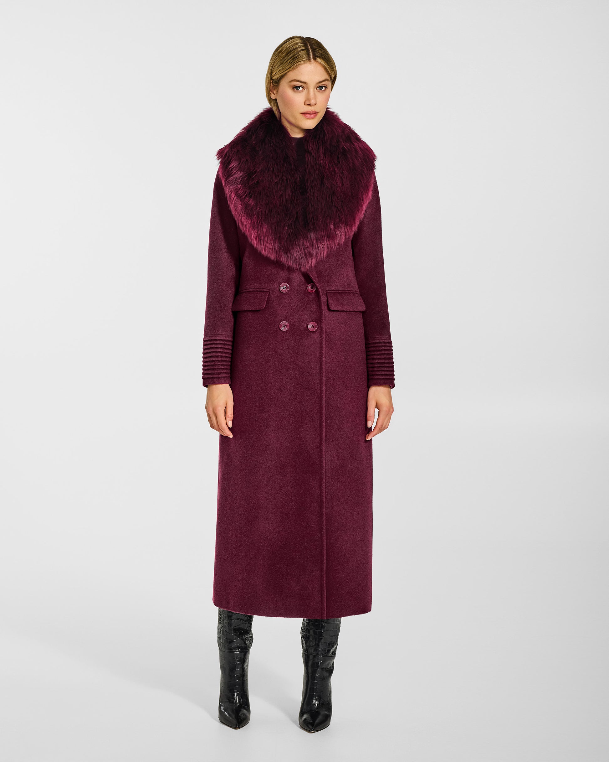 Front view of model wearing a Sentaler cherry lacquer double breasted maxi coat made of baby alpaca wool, with a peak collar, worn with alpaca shearling collar, buttoned.