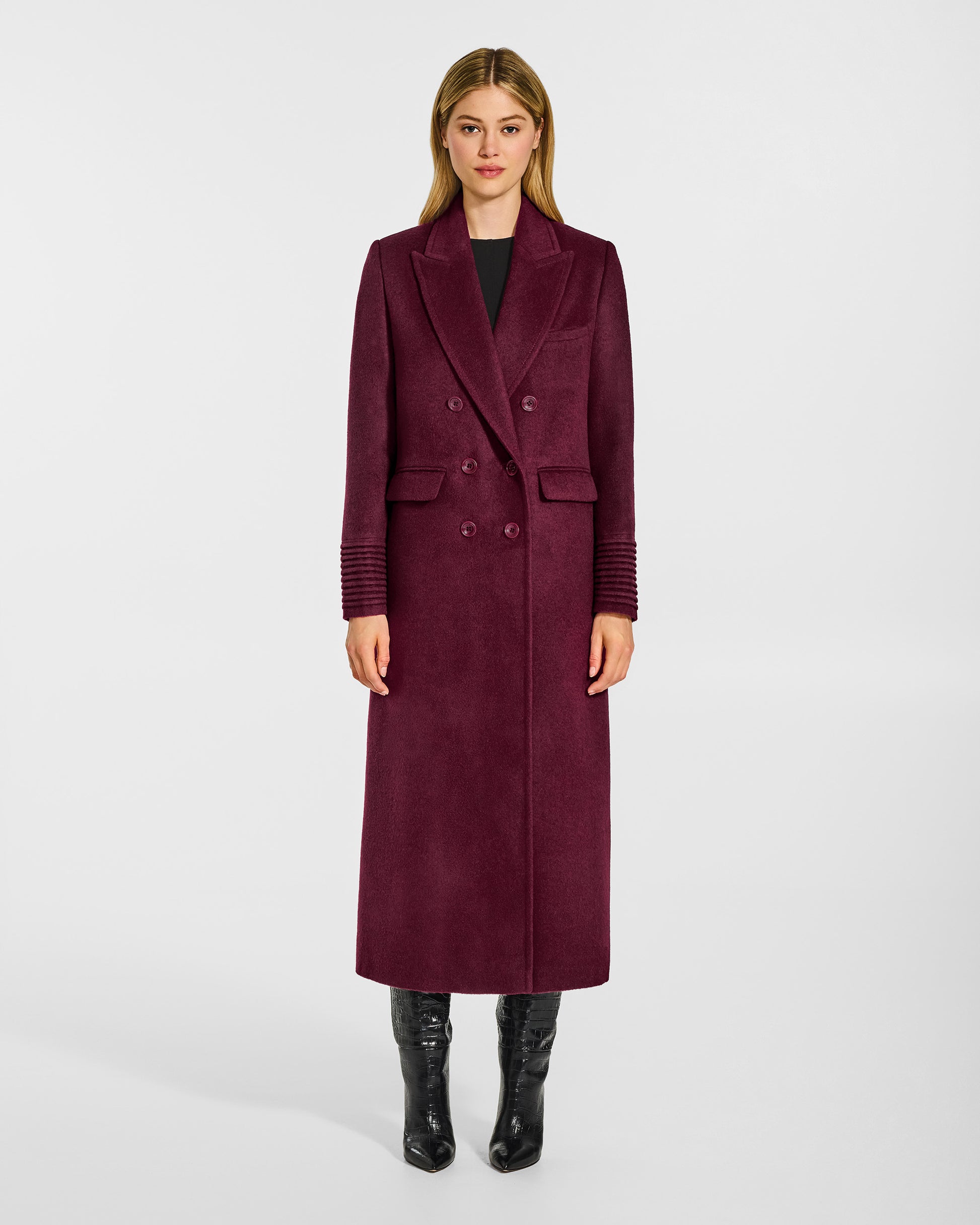 Front view of model wearing a Sentaler cherry lacquer double breasted maxi coat made of baby alpaca wool, with a peak collar, worn buttoned.