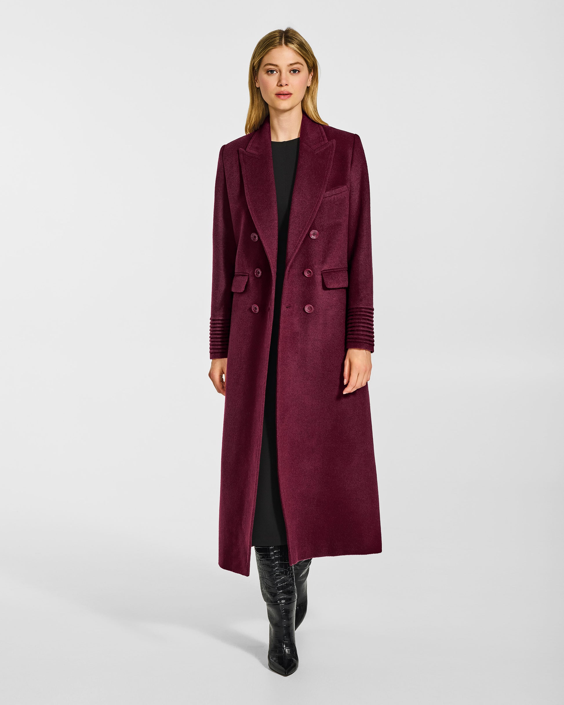 Front view of model wearing a Sentaler cherry lacquer double breasted maxi coat made of baby alpaca wool, with a peak collar, worn open.