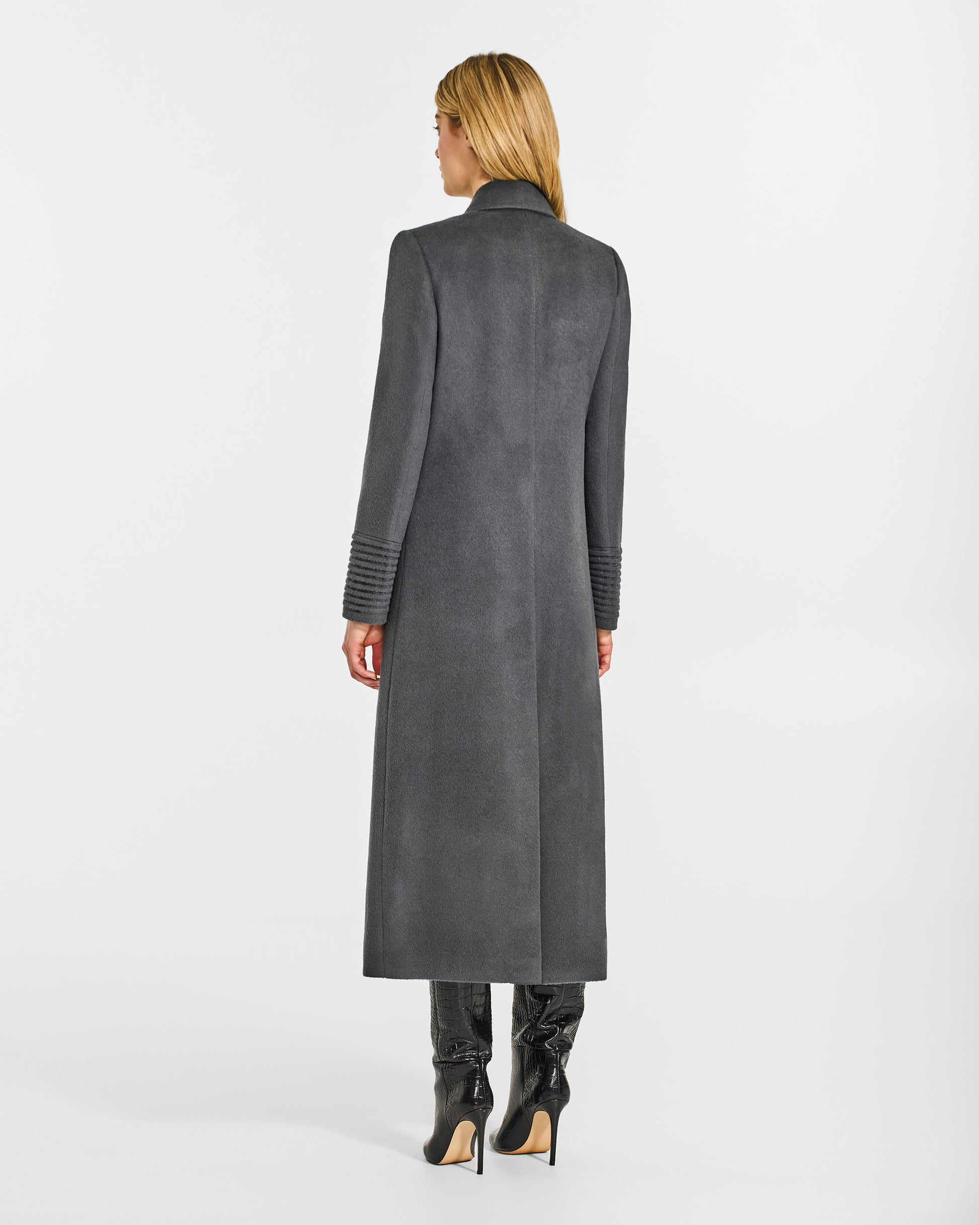 Back view of model wearing a Sentaler graphite grey double breasted maxi coat made of baby alpaca wool, with a peak collar, worn buttoned.