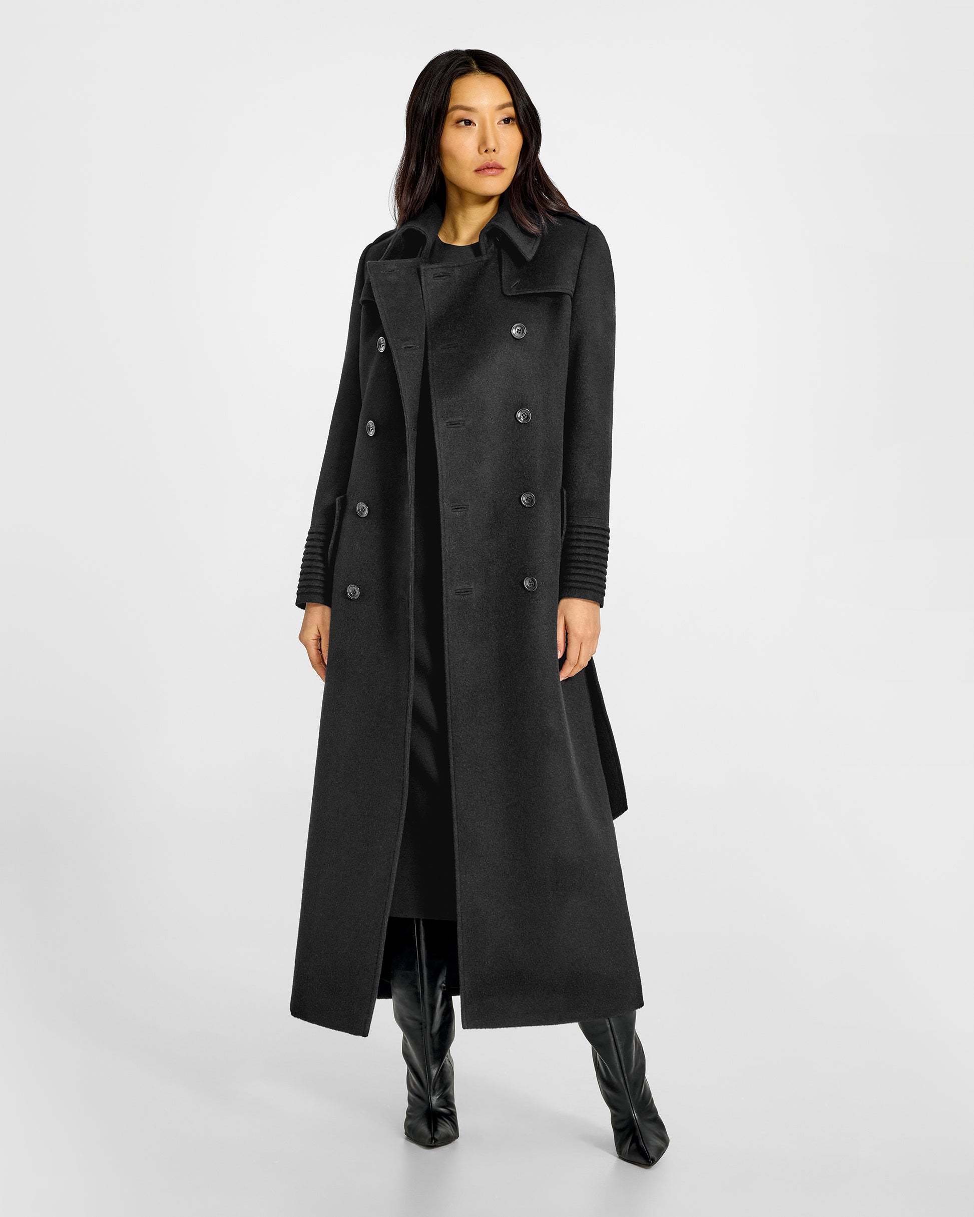 Front view of model in Sentaler maxi black trench coat made of baby alpaca wool, with a spread collar, worn open.