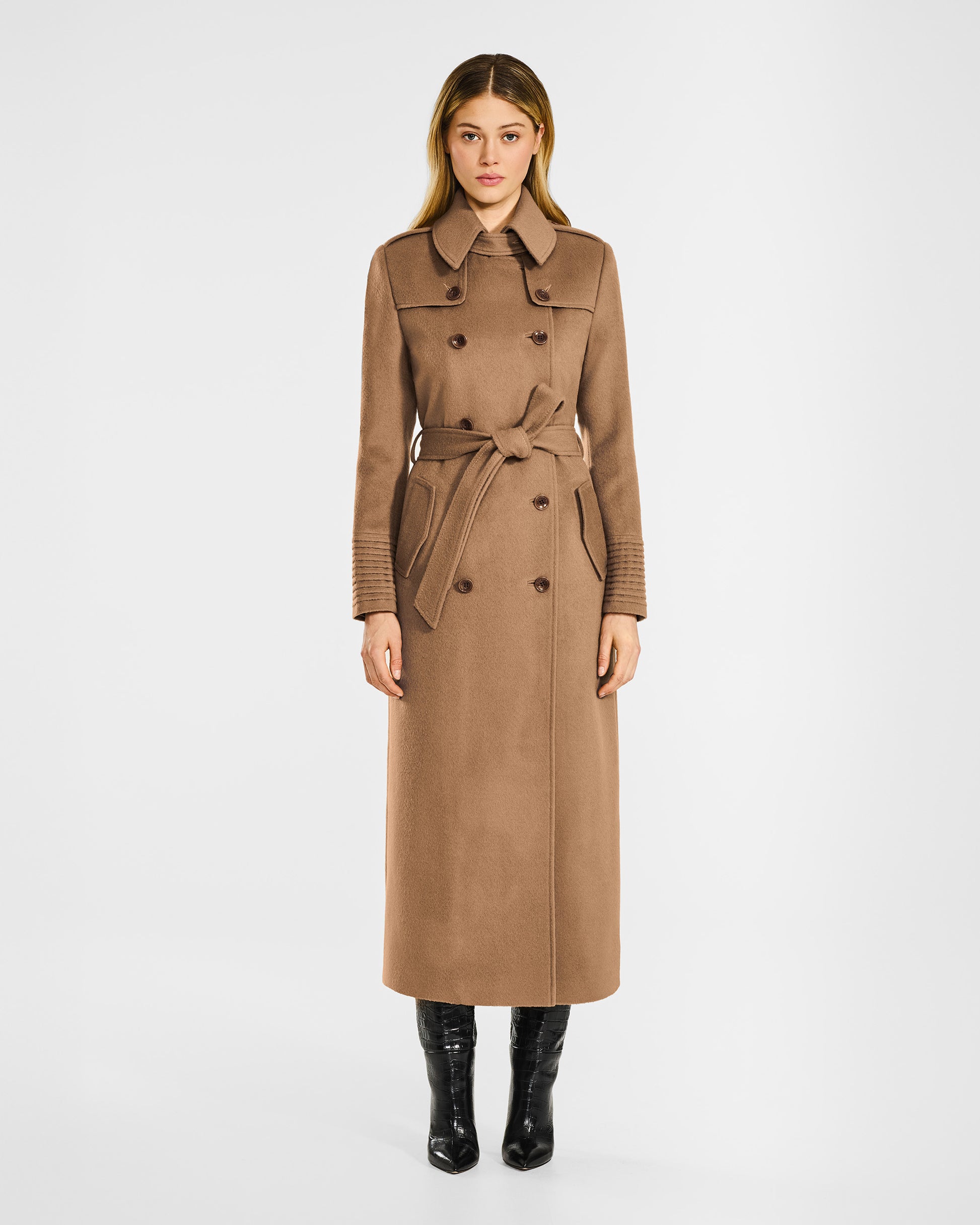 Front view of model in Sentaler maxi dark camel trench coat in baby alpaca wool, buttoned and belted.