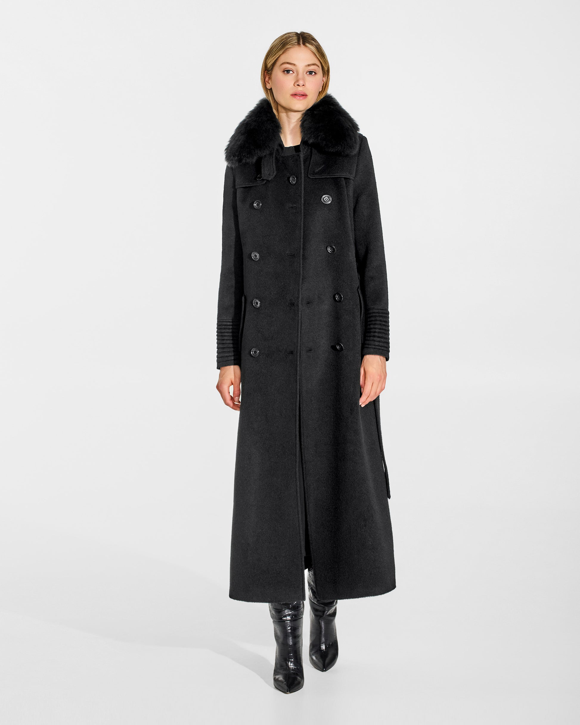 Front view of model in Sentaler maxi black trench coat made of baby alpaca wool with shearling collar, open. 
