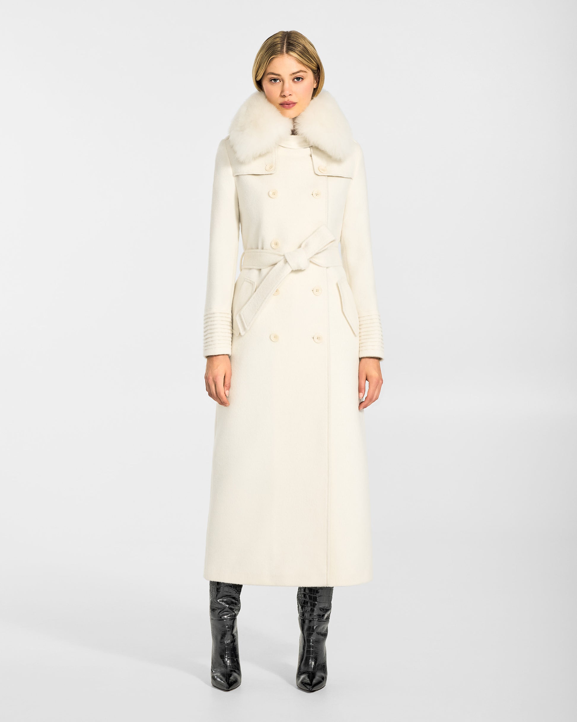 Front view of model in Sentaler maxi ivory trench coat made of baby alpaca wool with shearling collar, belted.