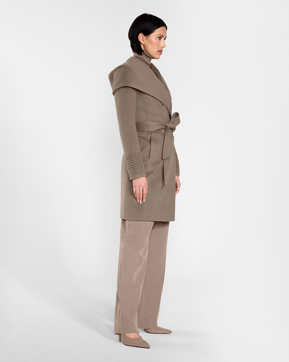 Sentaler Mid Length Hooded Wrap Warm Taupe Coat in Baby Alpaca wool. Seen from side belted on female model.