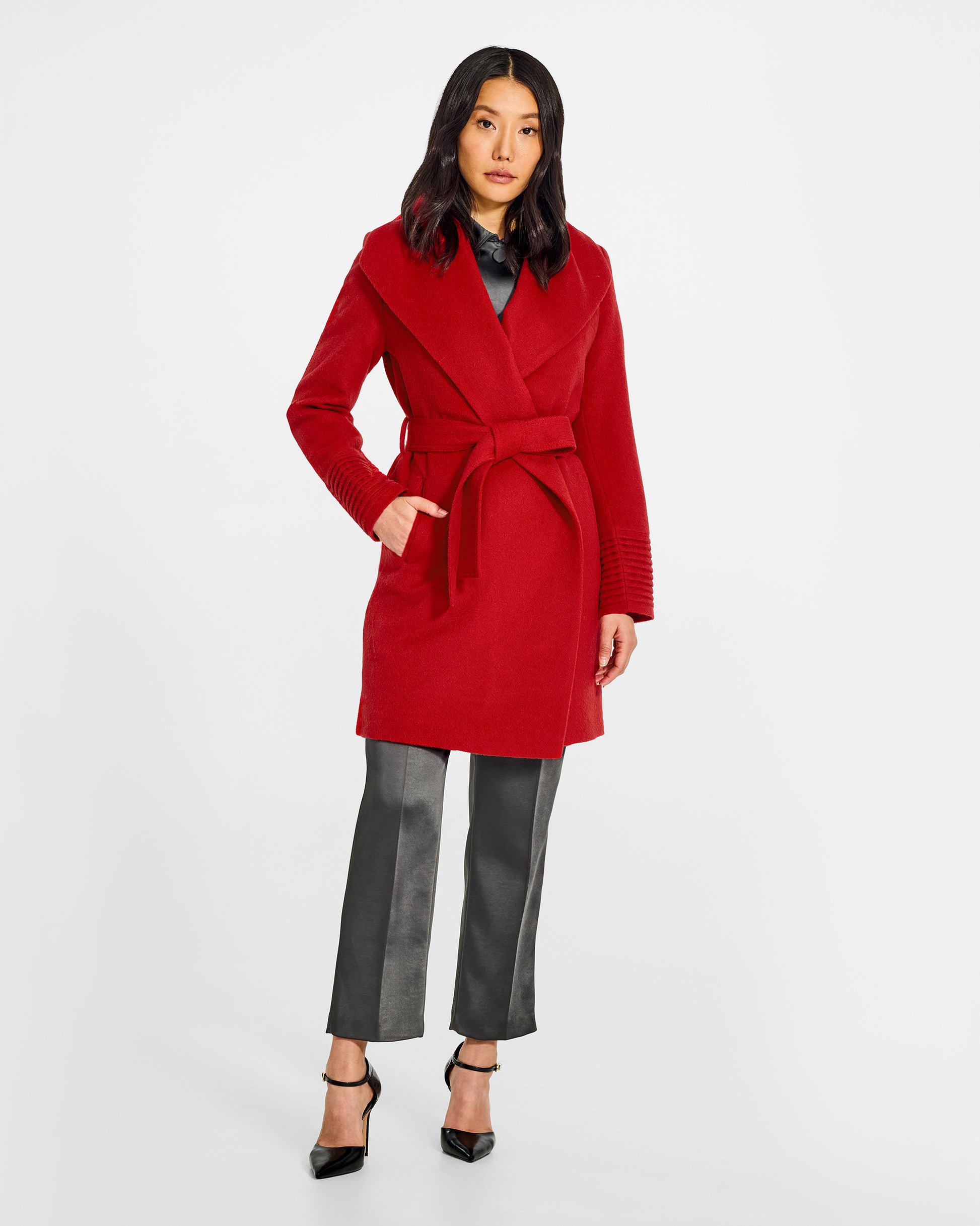 Front view of model wearing a Sentaler scarlet red long wrap coat made of baby alpaca wool, with a wide collar, worn belted.