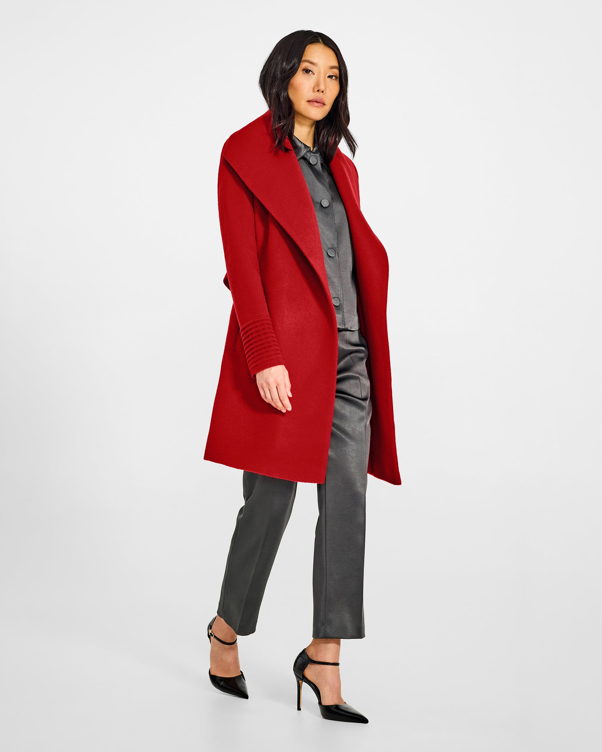Side view of model wearing a Sentaler scarlet red long wrap coat made of baby alpaca wool, with a wide collar, worn open.