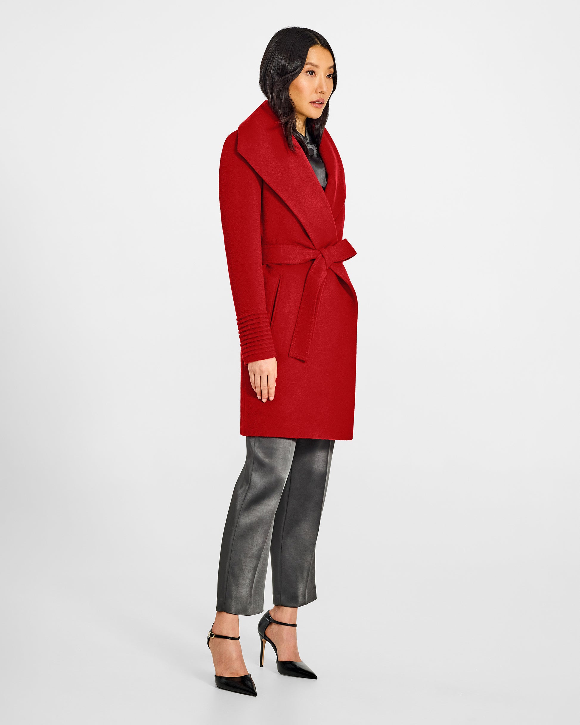 Side view of model wearing a Sentaler scarlet red long wrap coat made of baby alpaca wool, with a wide collar, worn belted.