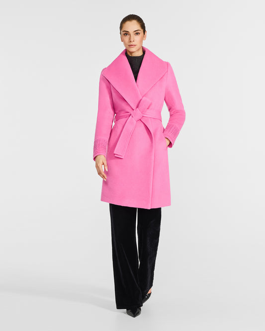 Front view of model wearing a Sentaler mid length cosmetic pink coat made of baby alpaca wool, with a shawl collar, worn belted.