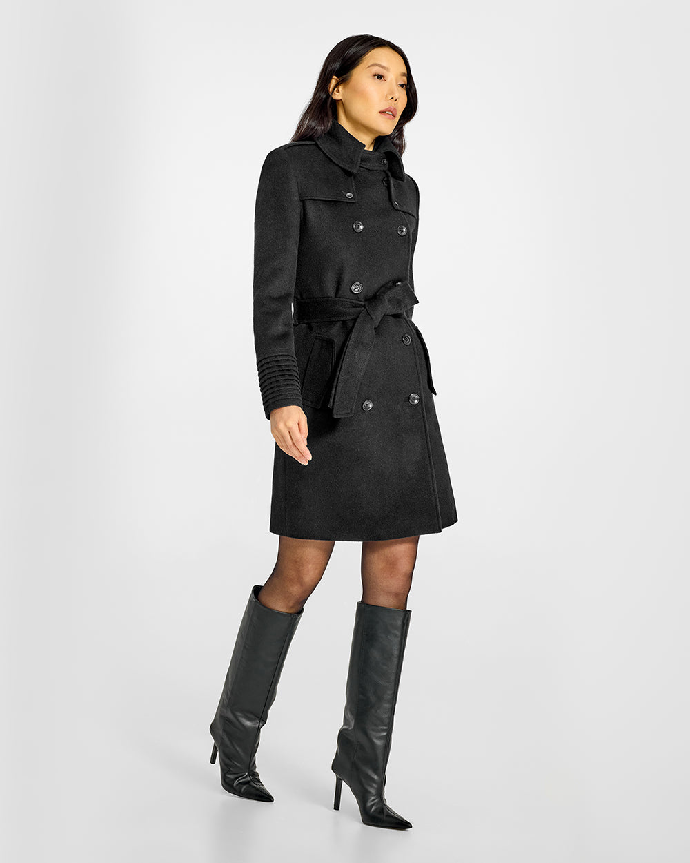 Sentaler Mid Length Trench Black Coat in Baby Alpaca wool. Seen from side belted on female model.