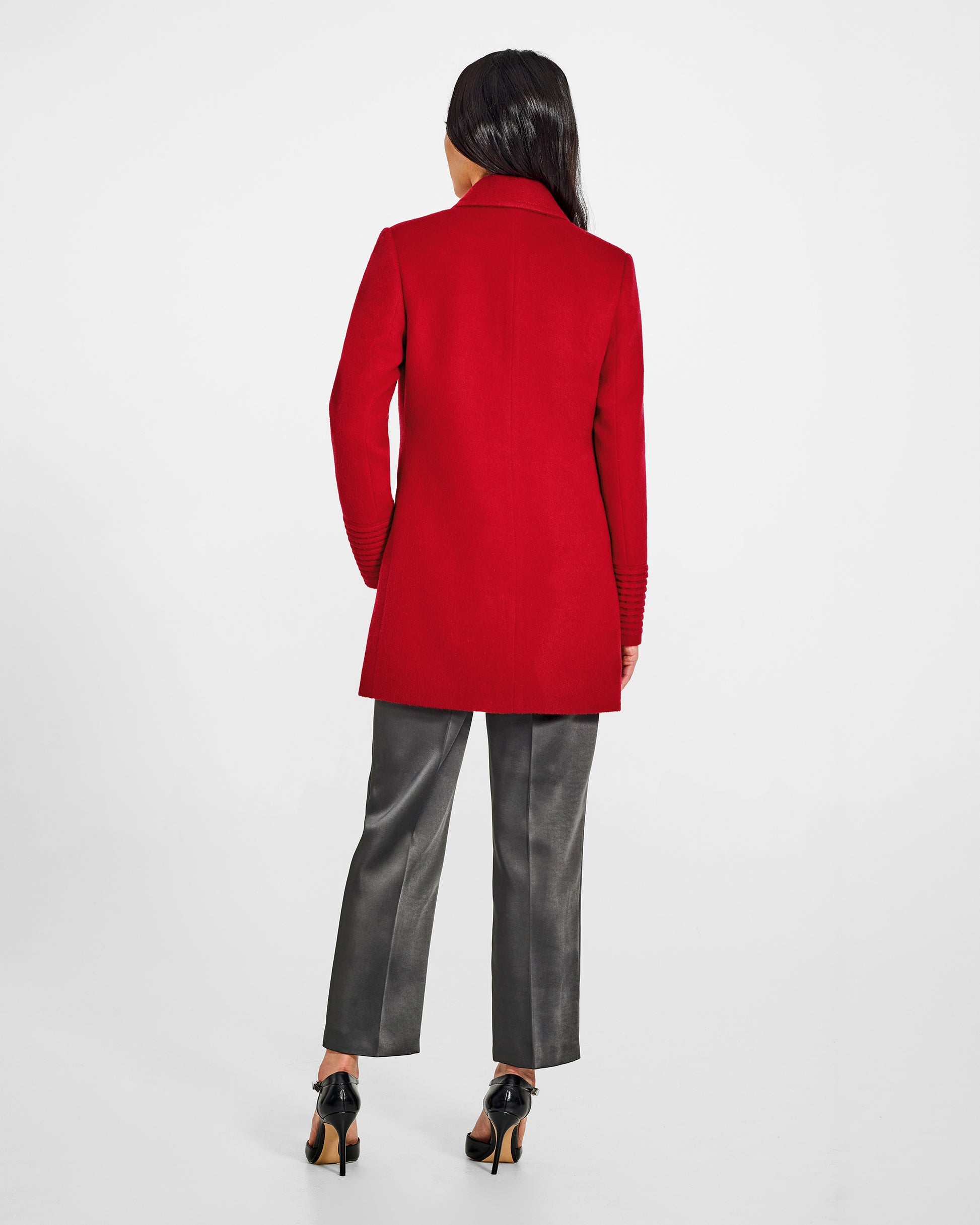 Back view of model wearing a Sentaler scarlet red topcoat made of baby alpaca wool, with a peak collar, worn buttoned.