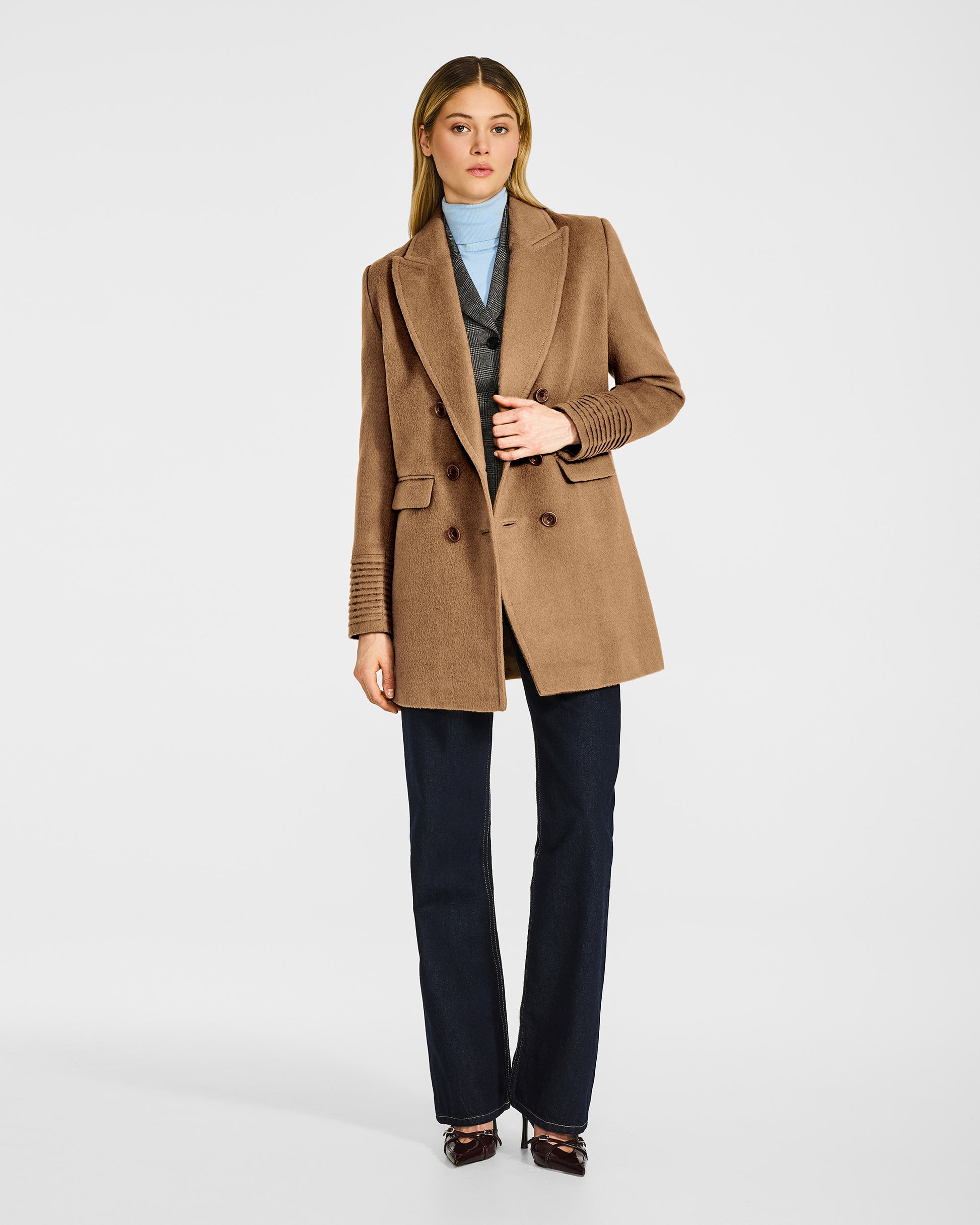 Front view of model wearing a Sentaler dark camel topcoat made of baby alpaca wool, open.