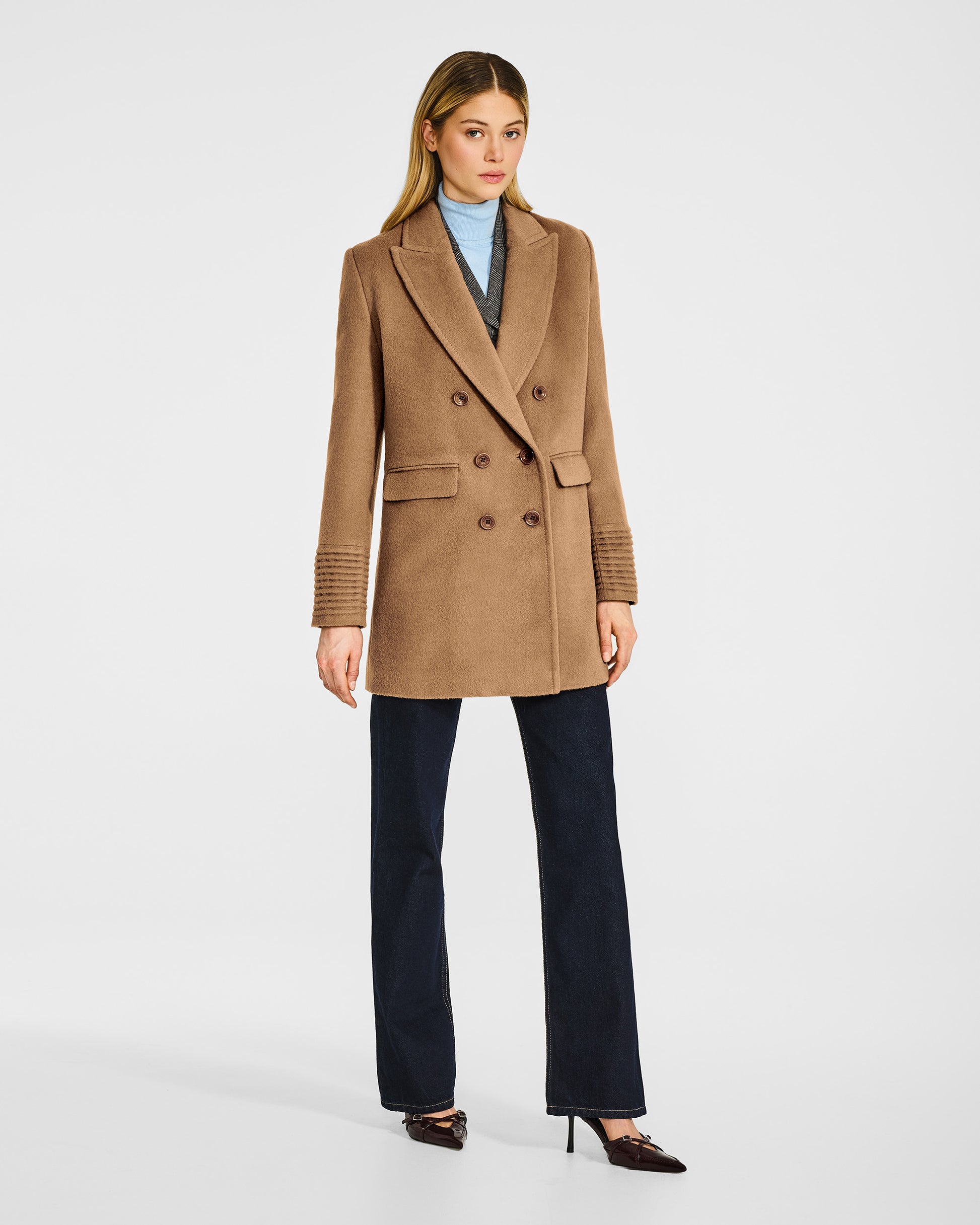Front view of model wearing a Sentaler dark camel topcoat made of baby alpaca wool, buttoned.