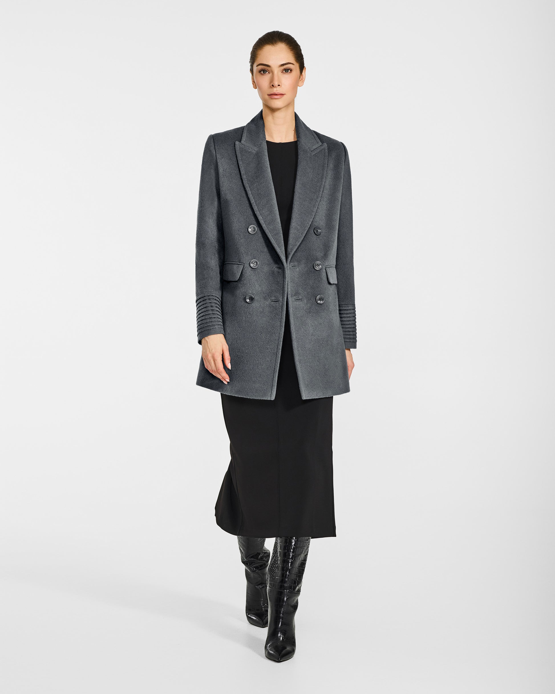 Front view of model wearing a Sentaler graphite grey topcoat made of baby alpaca wool, with a peak collar, worn open.