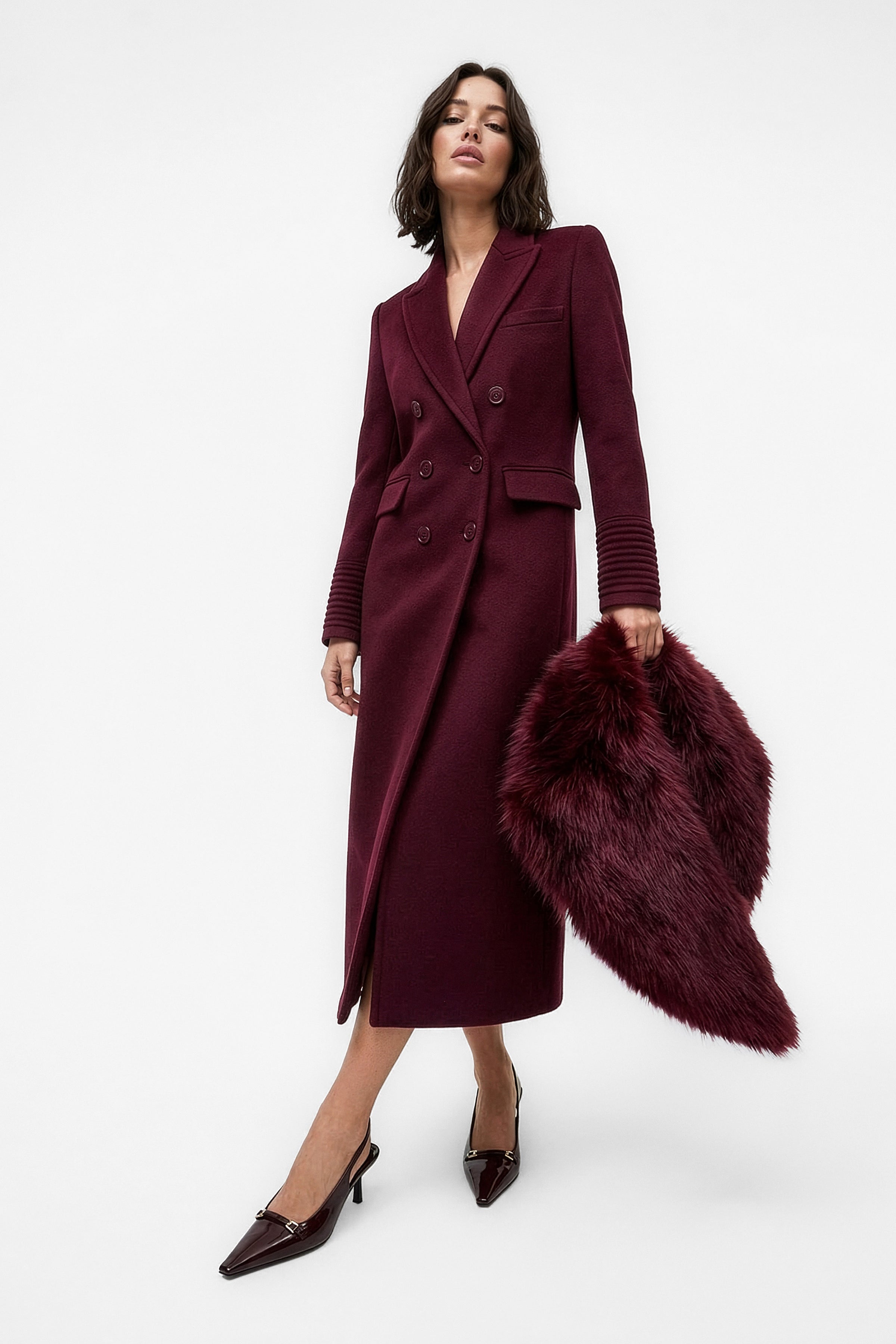 Front view of model wearing a Sentaler cherry lacquer double breasted maxi coat made of baby alpaca wool, with a peak collar, worn buttoned, paired with a cherry lacquer shearling collar.