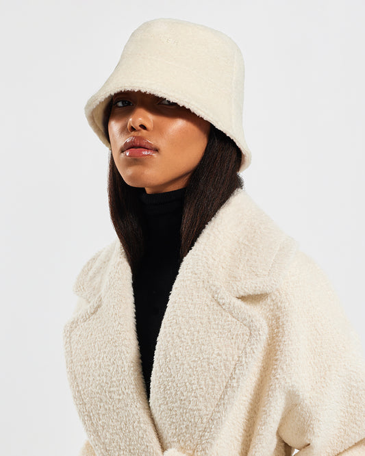 Sentaler Bouclé Alpaca Bucket Ivory Hat in Bouclé Alpaca wool. Seen from side close up on female model.