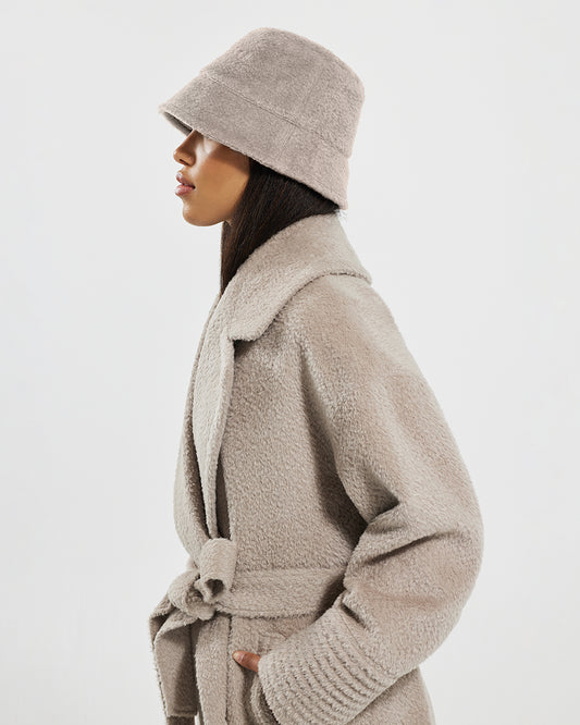 Sentaler Bouclé Alpaca Bucket Sand Hat in Bouclé Alpaca wool. Seen from side close up on female model.