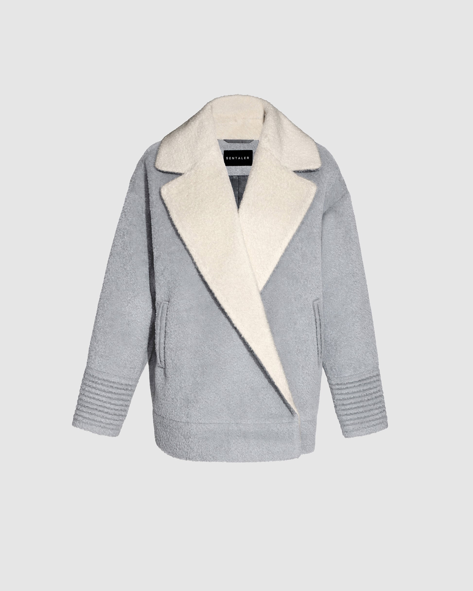 Sentaler glacial grey aviator jacket made of bouclé alpaca wool, with dropped shoulders, buttoned.