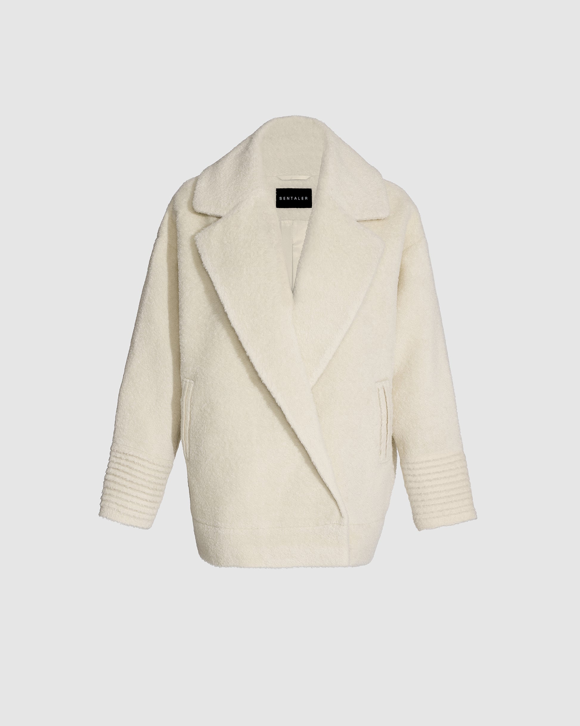 Sentaler ivory aviator jacket made of bouclé alpaca wool, with dropped shoulders, buttoned.