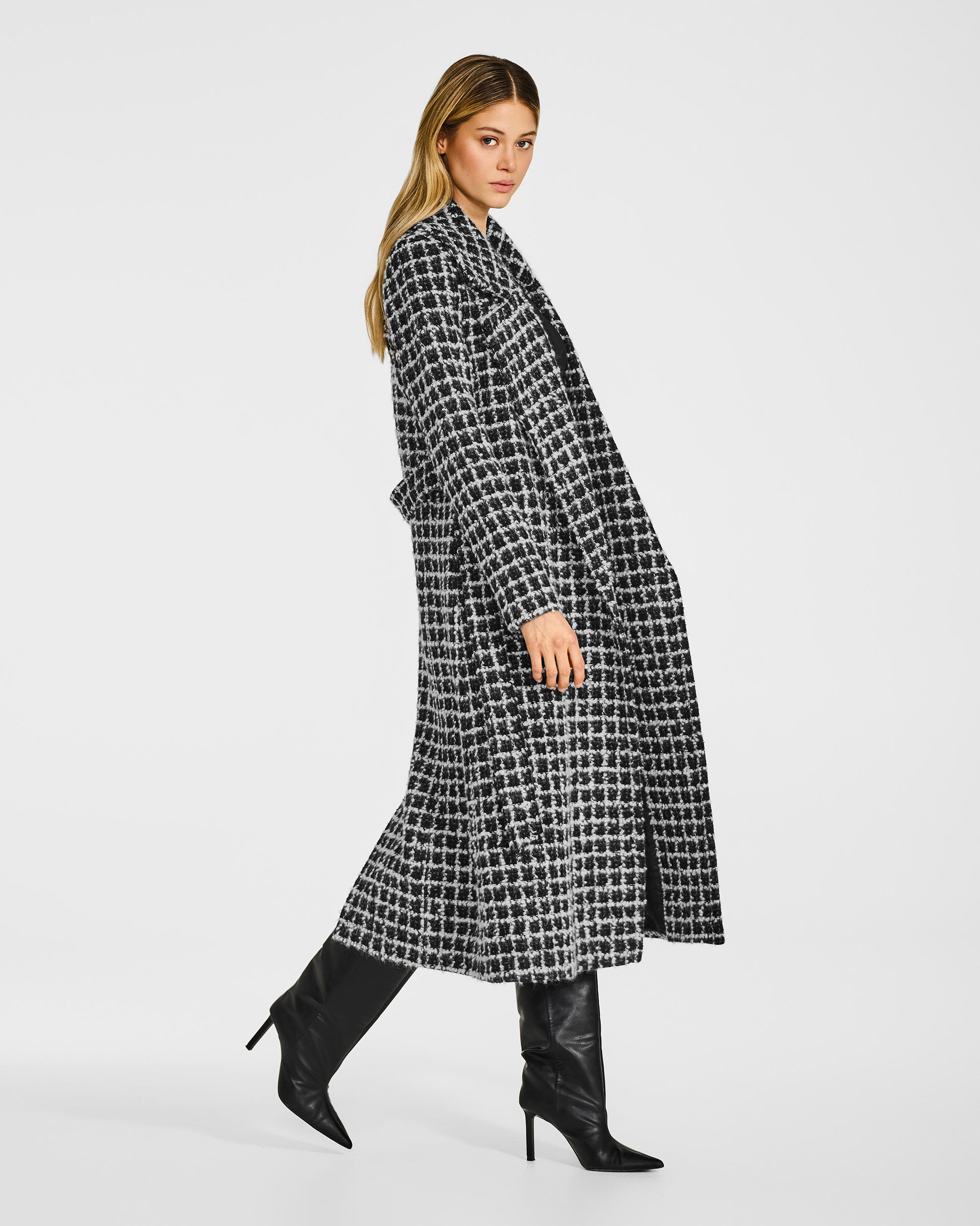 Side view of model wearing a Sentaler black check wrap coat made of suri alpaca wool, with a notched collar.