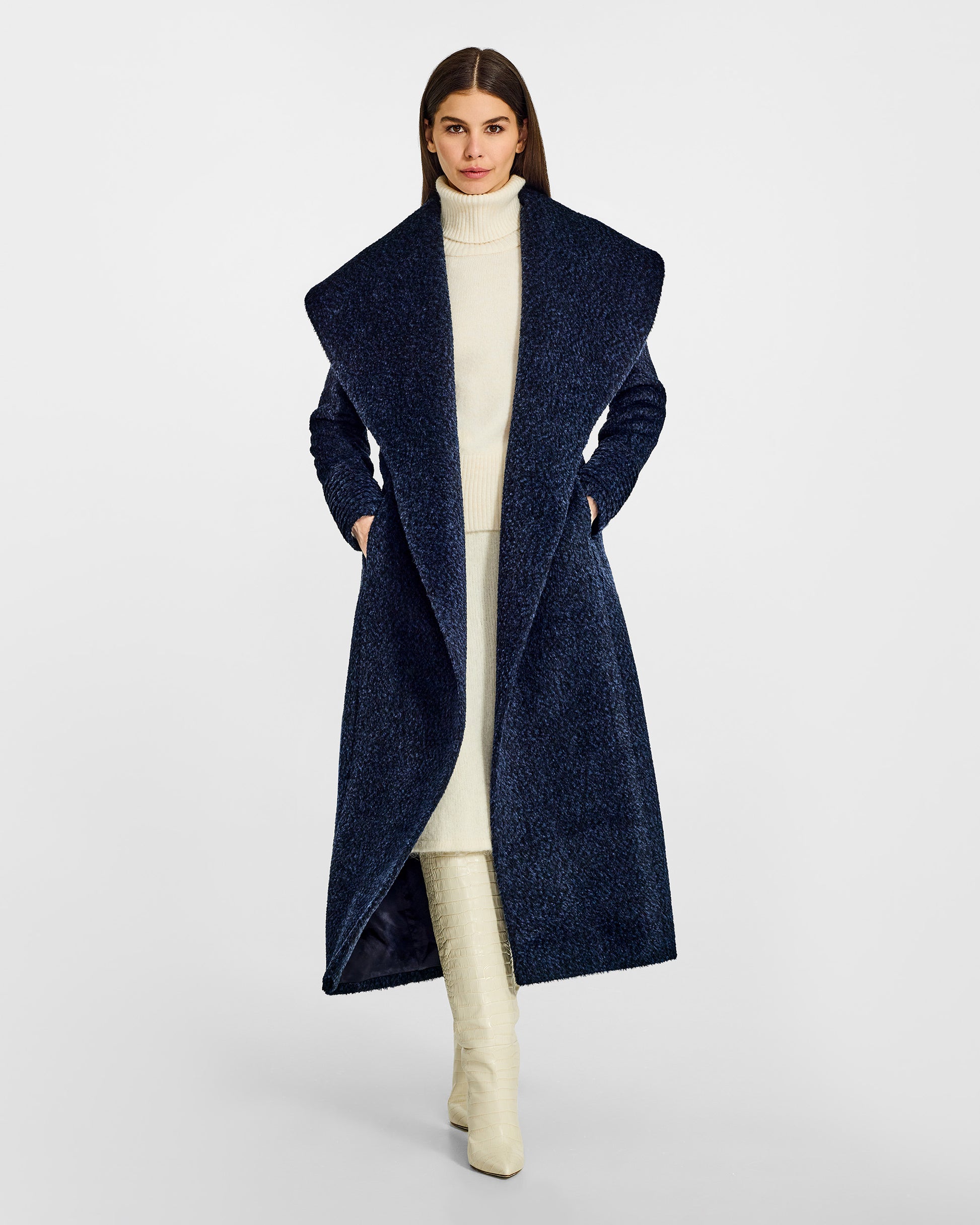 Front view of model wearing a Sentaler midnight blue maxi wrap coat made of bouclé alpaca wool, with a wide shawl collar, worn open.