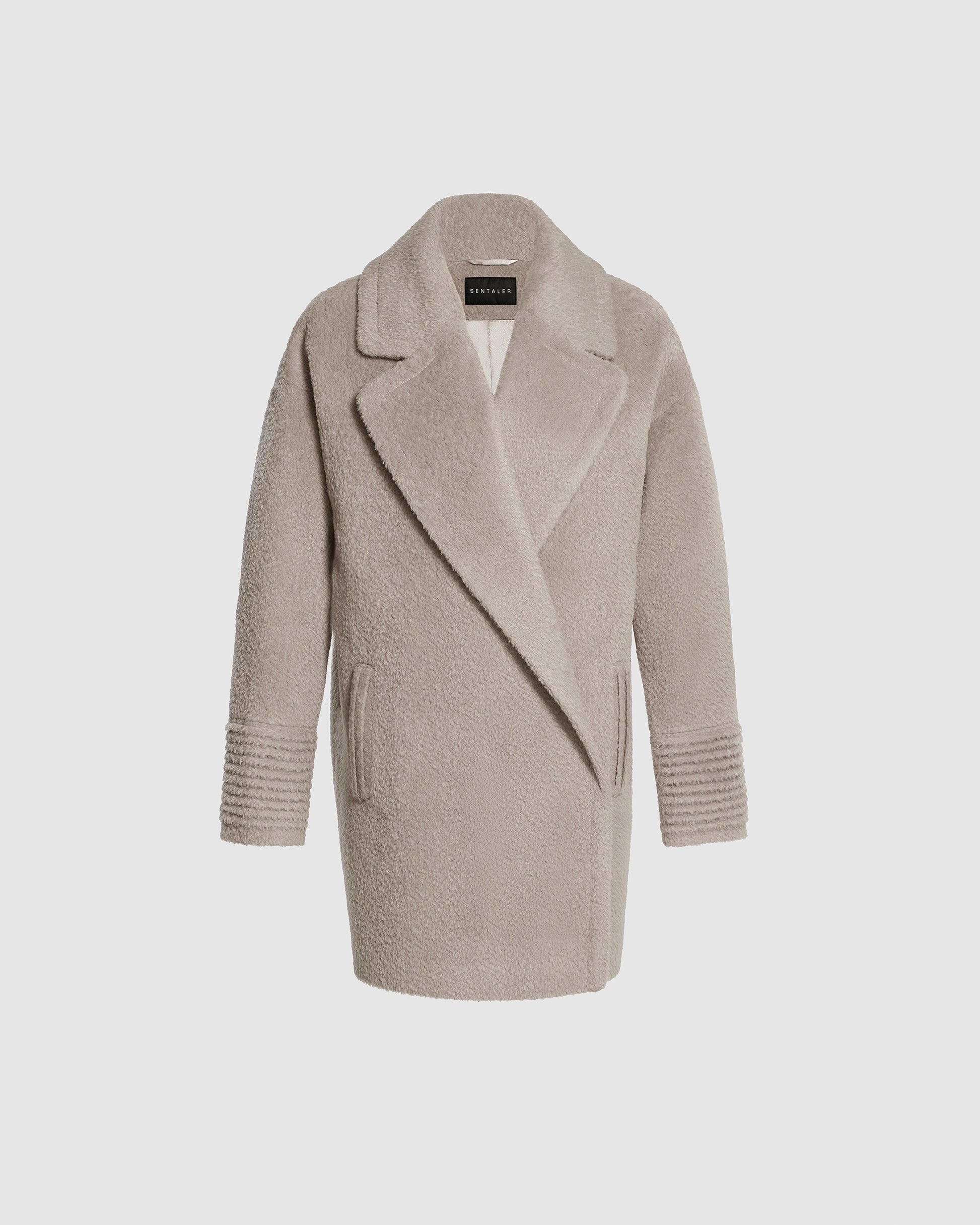 Sentaler mid length sand oversized coat made of bouclé alpaca wool with a notched collar, buttoned.