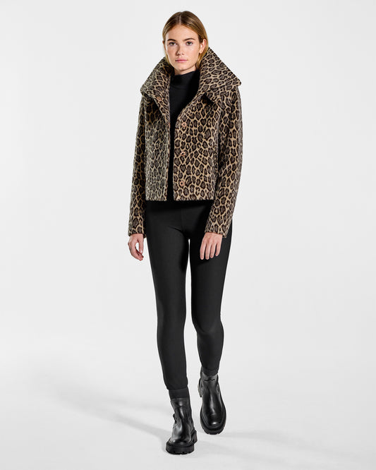 Front view of model wearing a Sentaler leopard moto jacket made of bouclé alpaca wool, with a double collar, worn open.