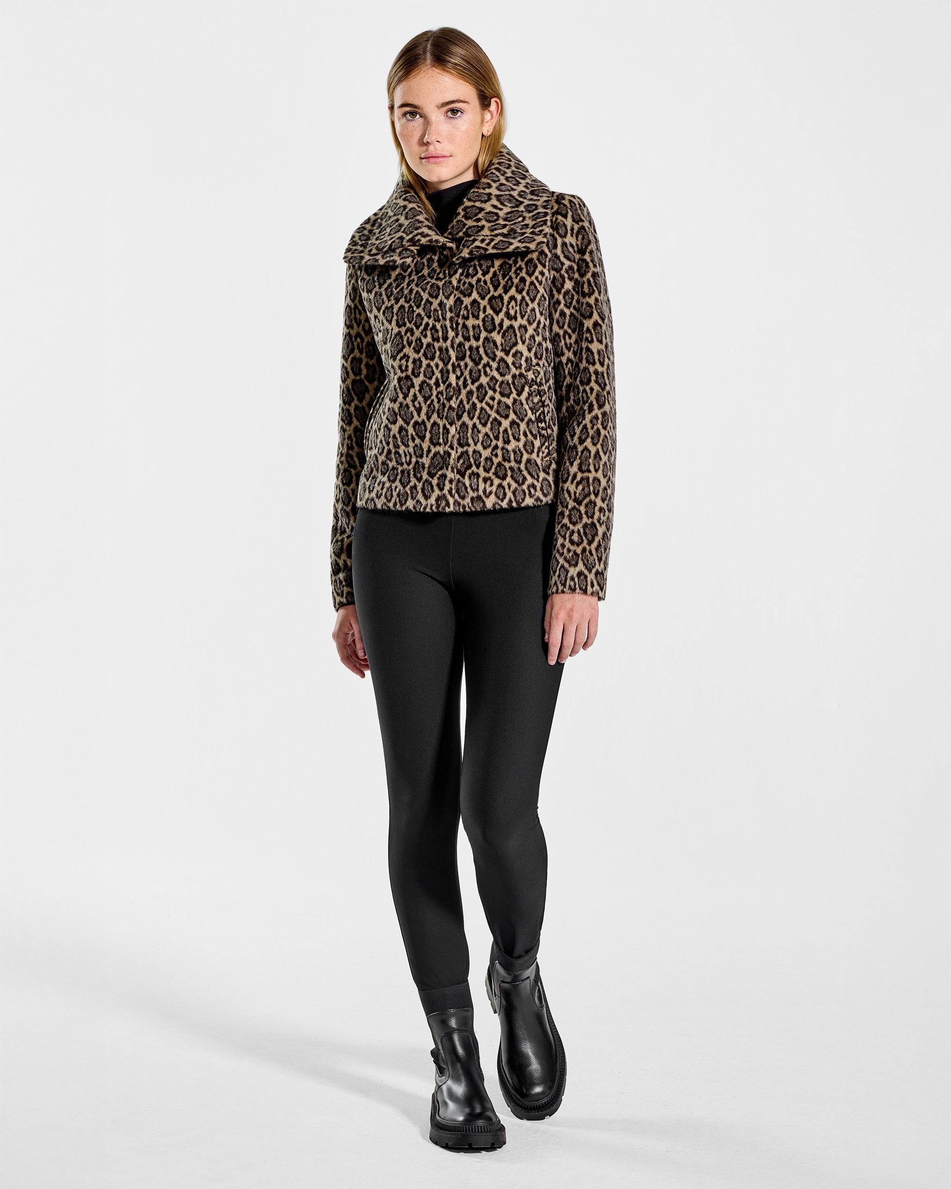 Front view of model wearing a Sentaler leopard moto jacket made of bouclé alpaca wool, with a double collar, worn buttoned.