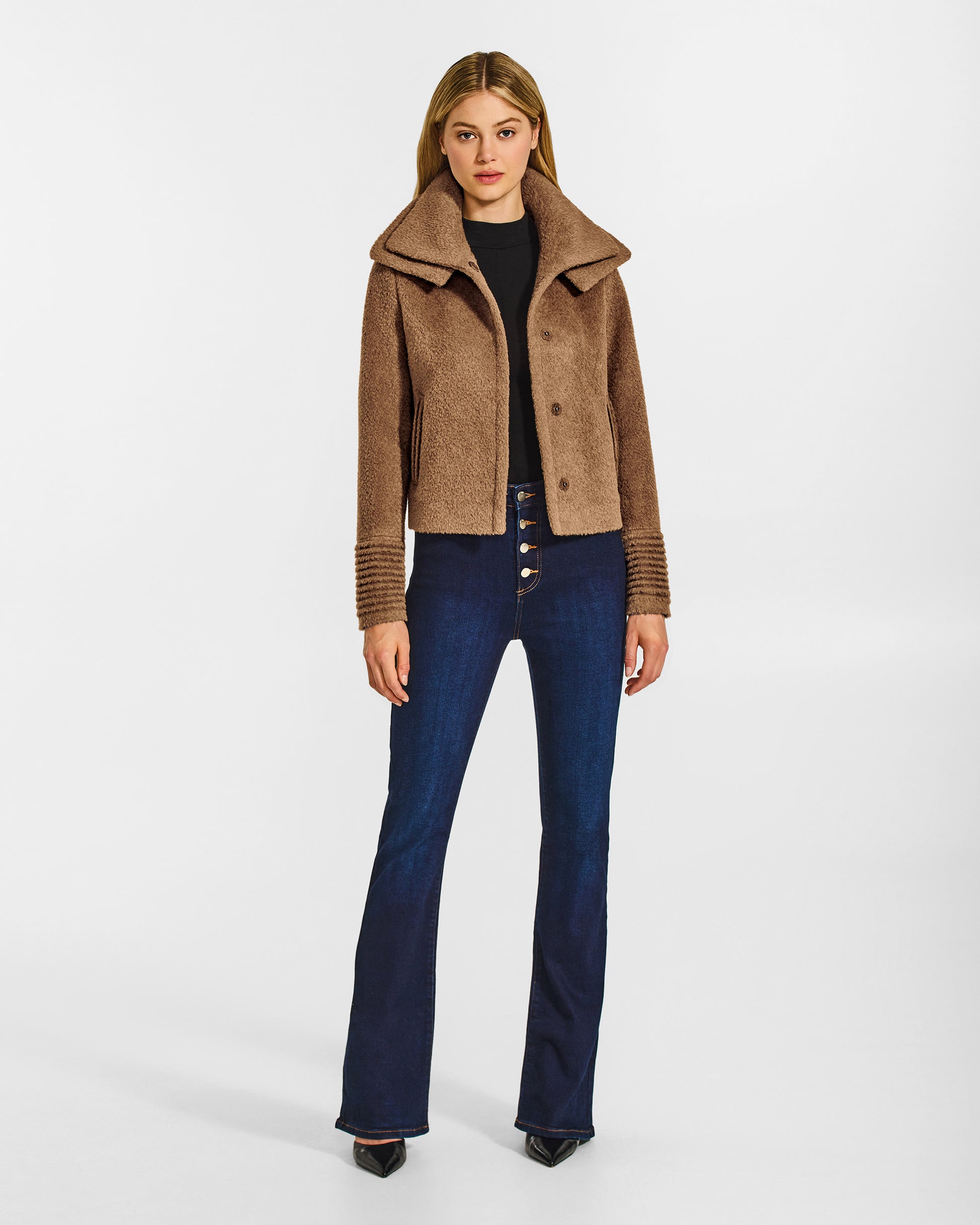 Front view of model wearing a Sentaler dark camel moto jacket made of bouclé alpaca wool, with a double collar, worn open.