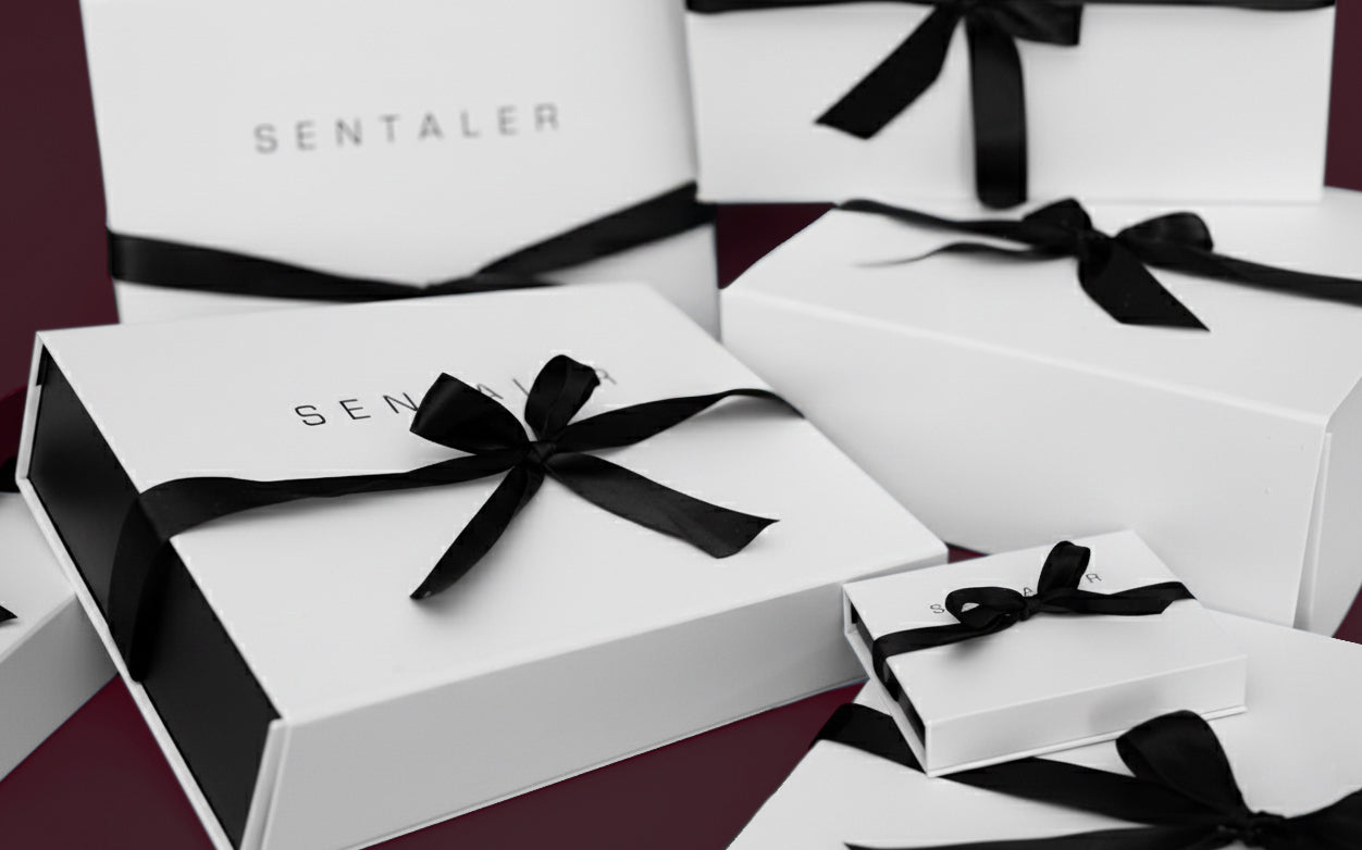 Luxury Sentaler gift boxes, displayed on cherry lacquer background.