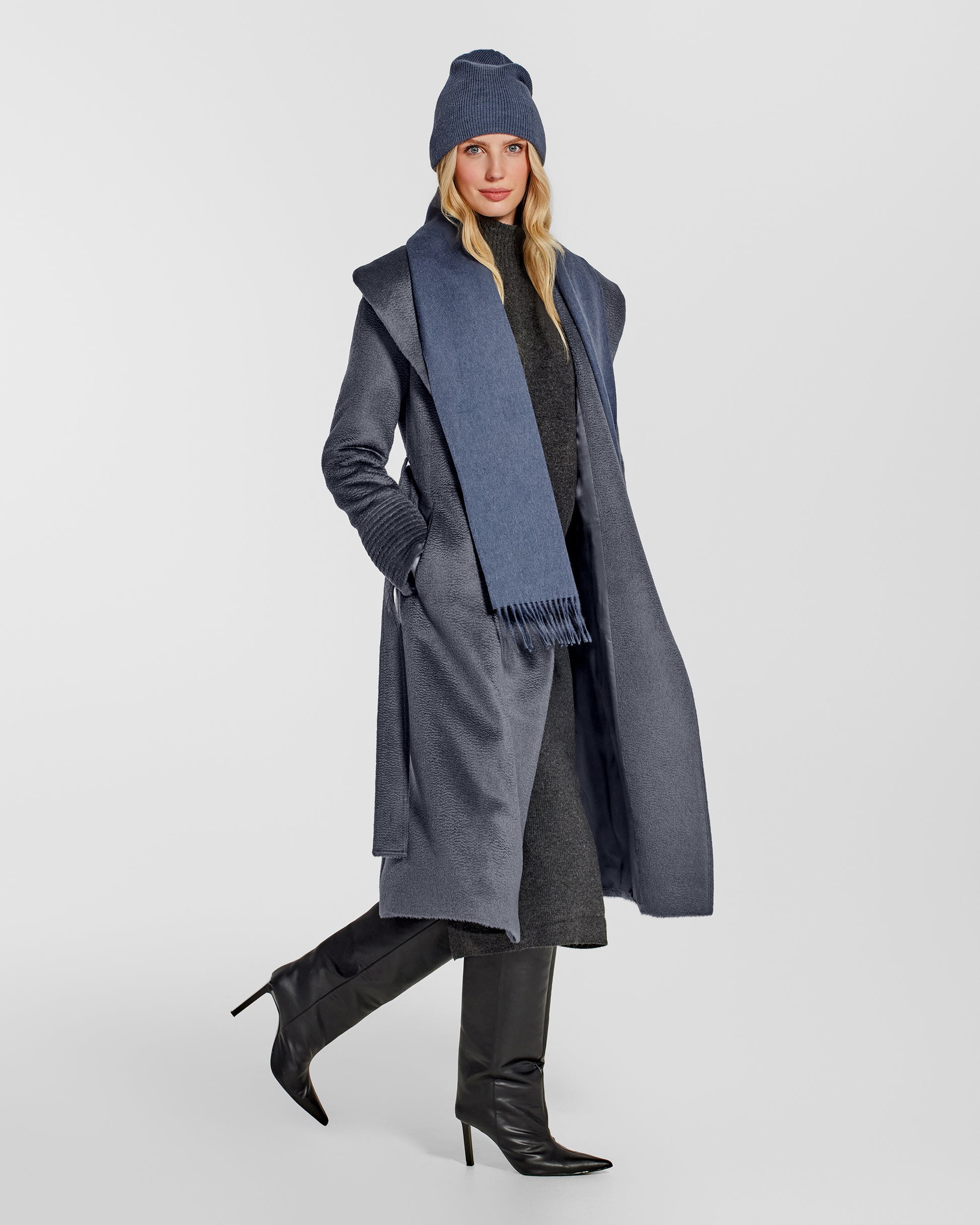 Side view of model wearing Sentaler's classic graphite beanie, made of baby alpaca yarn, paired with a graphite coat.