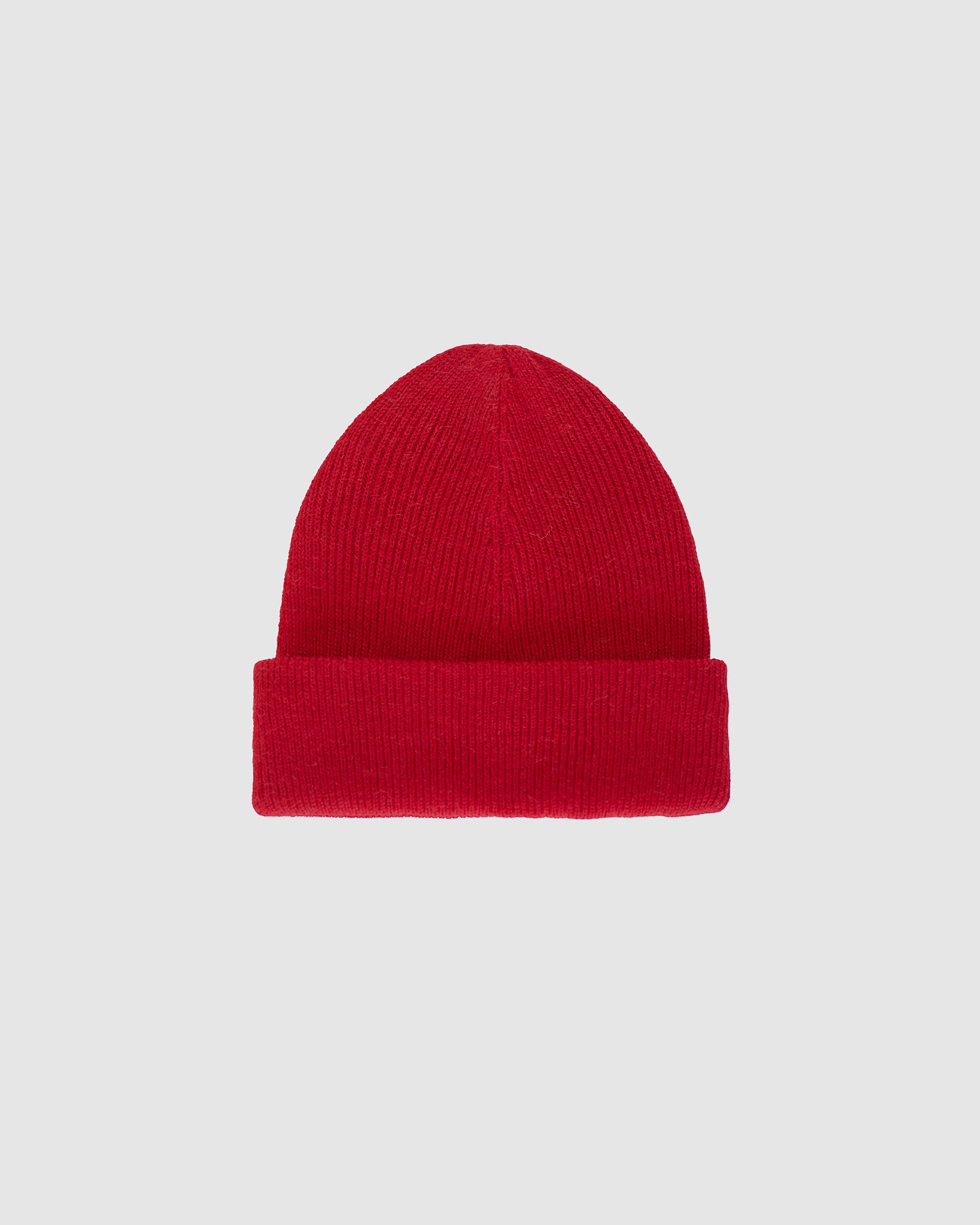 Sentaler classic red beanie made from baby alpaca yarn, displayed on a white background.