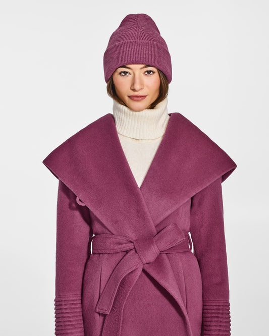 Front view of model wearing Sentaler's classic mauve pink beanie, made of baby alpaca yarn, paired with a mauve pink coat.