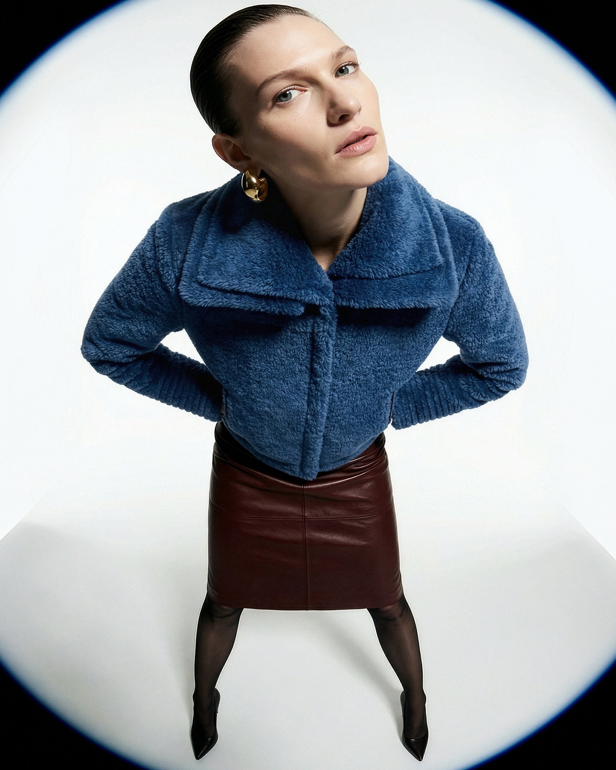 Front view of model wearing a Sentaler classic blue moto jacket made of bouclé alpaca wool, with a double collar, worn buttoned.