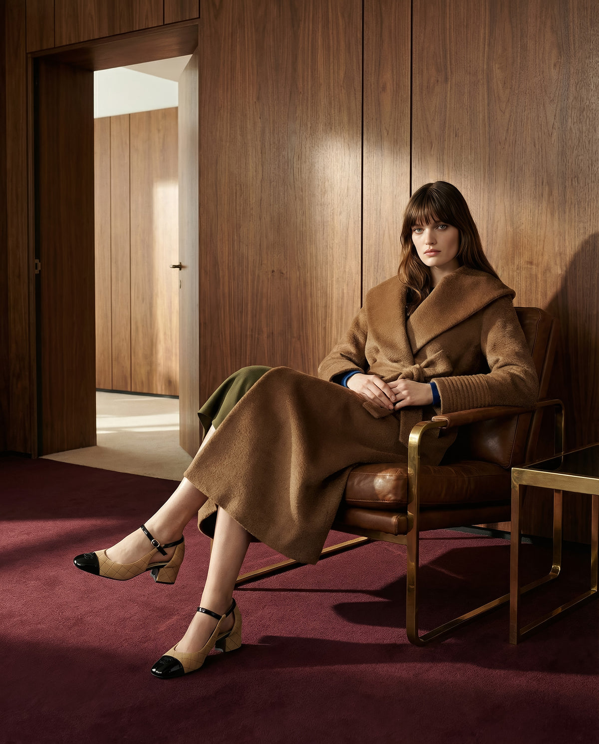 Side view of model wearing a Sentaler long dark camel wrap coat made of suri alpaca wool, with a shawl collar, worn belted.