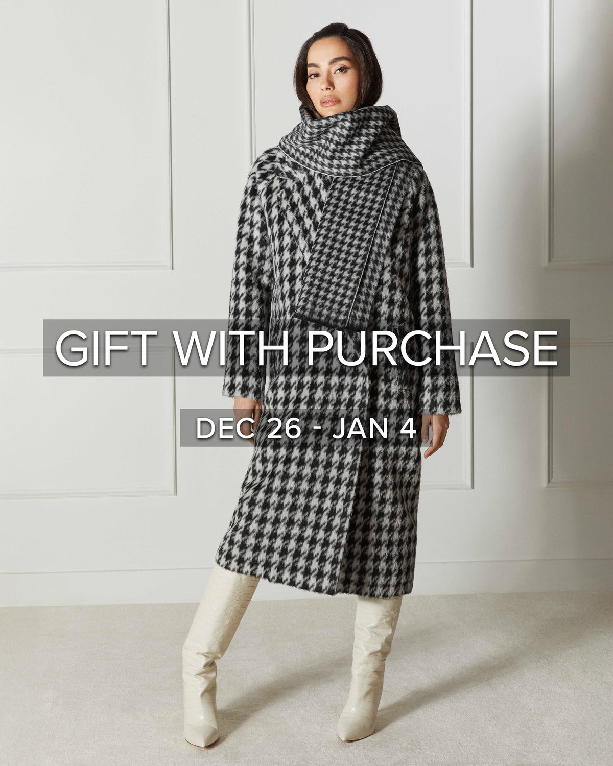 Front view of model wearing Sentaler's Black & White Houndstooth scarf, made of baby alpaca yarn. 