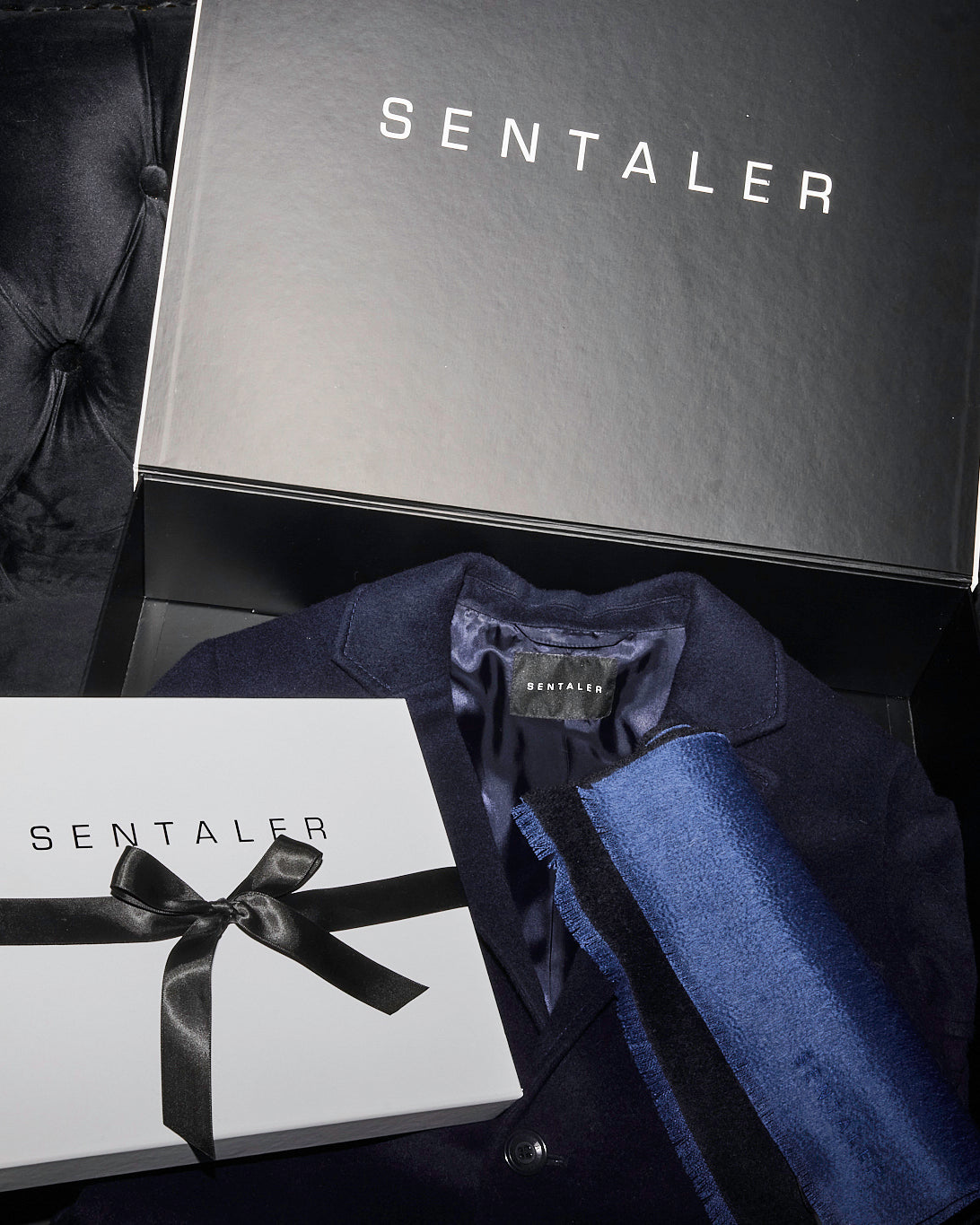 Sentaler Notched Lapel Deep Navy Overcoat in Baby Alpaca wool. Seen with Sentaler Double Sided Suri Alpaca Black-Blue Scarf in Suri Alpaca yarn. Seen as rolled off figure.