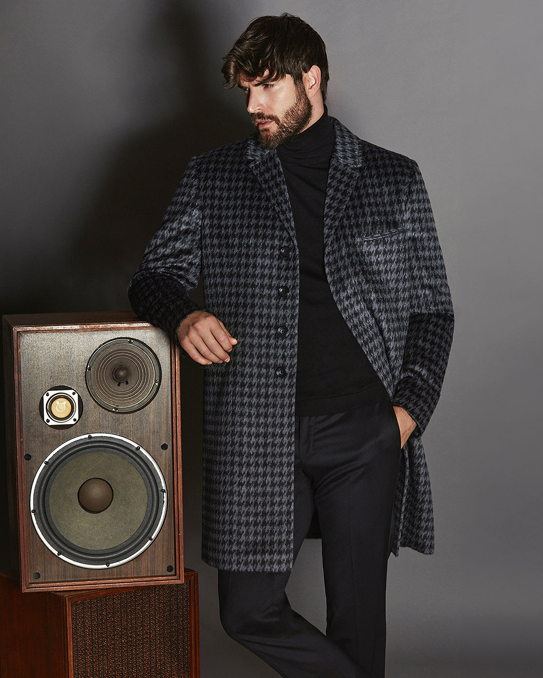 Sentaler Suri Alpaca Notched Lapel Black & Graphite Houndstooth Overcoat in Technical Suri Alpaca wool. Seen from front above the knees on male model.