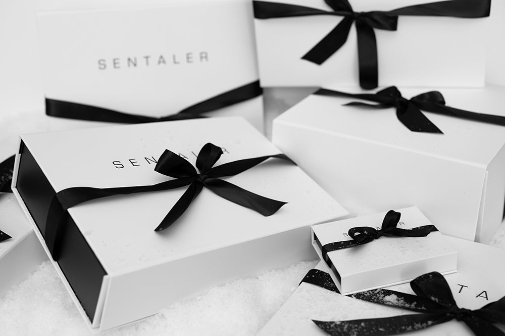 Wrapped SENTALER gift boxes in snow.