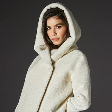 Sentaler Bouclé Alpaca Long Hooded Ivory Coat in Bouclé Alpaca wool. Seen from side close up on female model with hood.